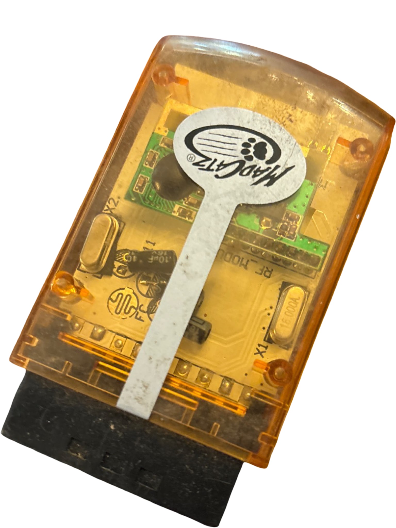 Transparent Orange Car Diagnostic OBD-II Scanner: A compact car diagnostic OBD-II scanner encased in a transparent orange plastic housing. The internal circuitry and components are visible through the transparent casing. Features a standard OBD-II