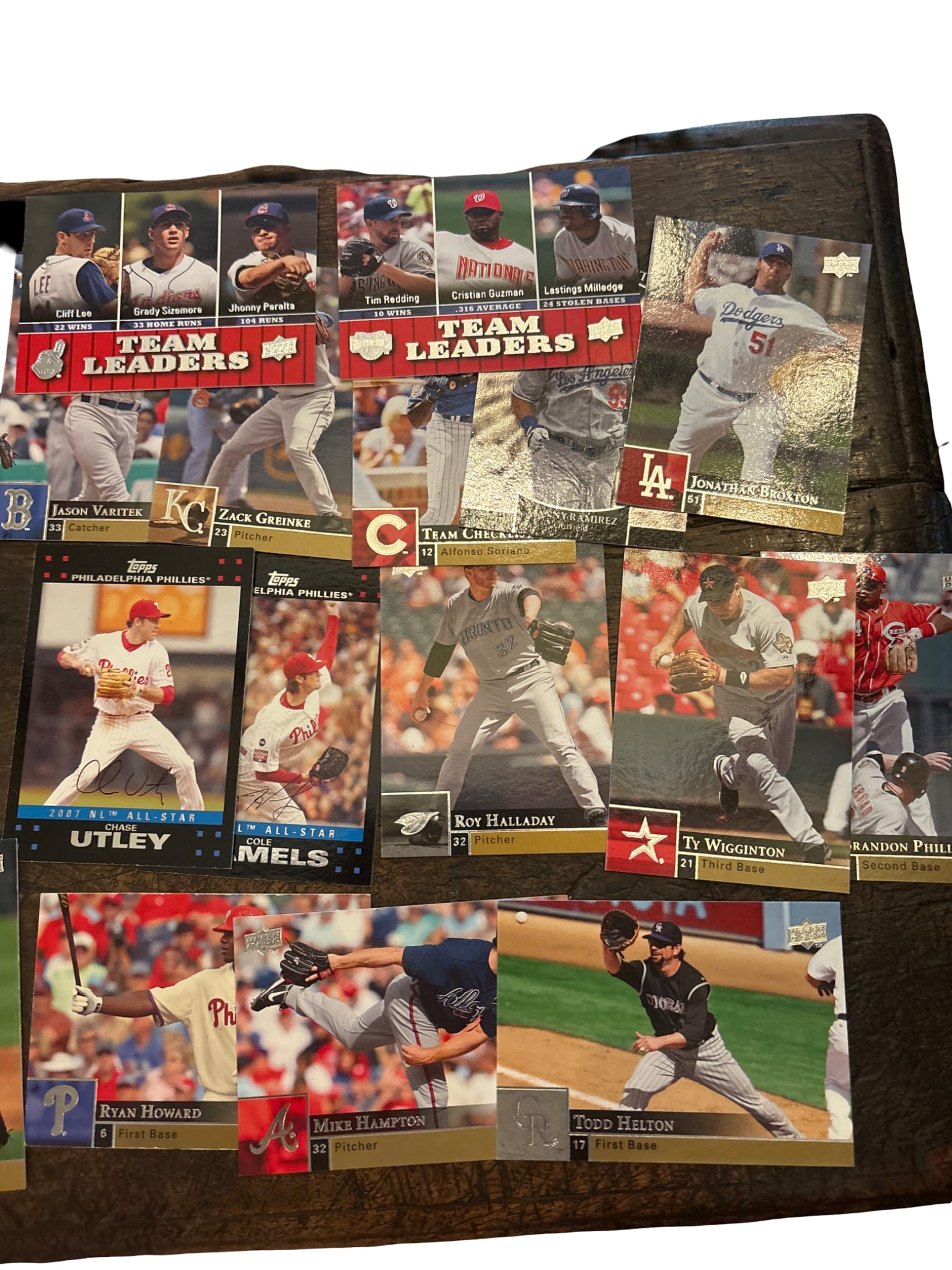 Baseball Trading Cards Featuring MLB Players: Collection of baseball trading cards featuring MLB players and teams. Includes notable themes such as 'Team Leaders' cards and individual player cards. Cards appear to span various years and teams,