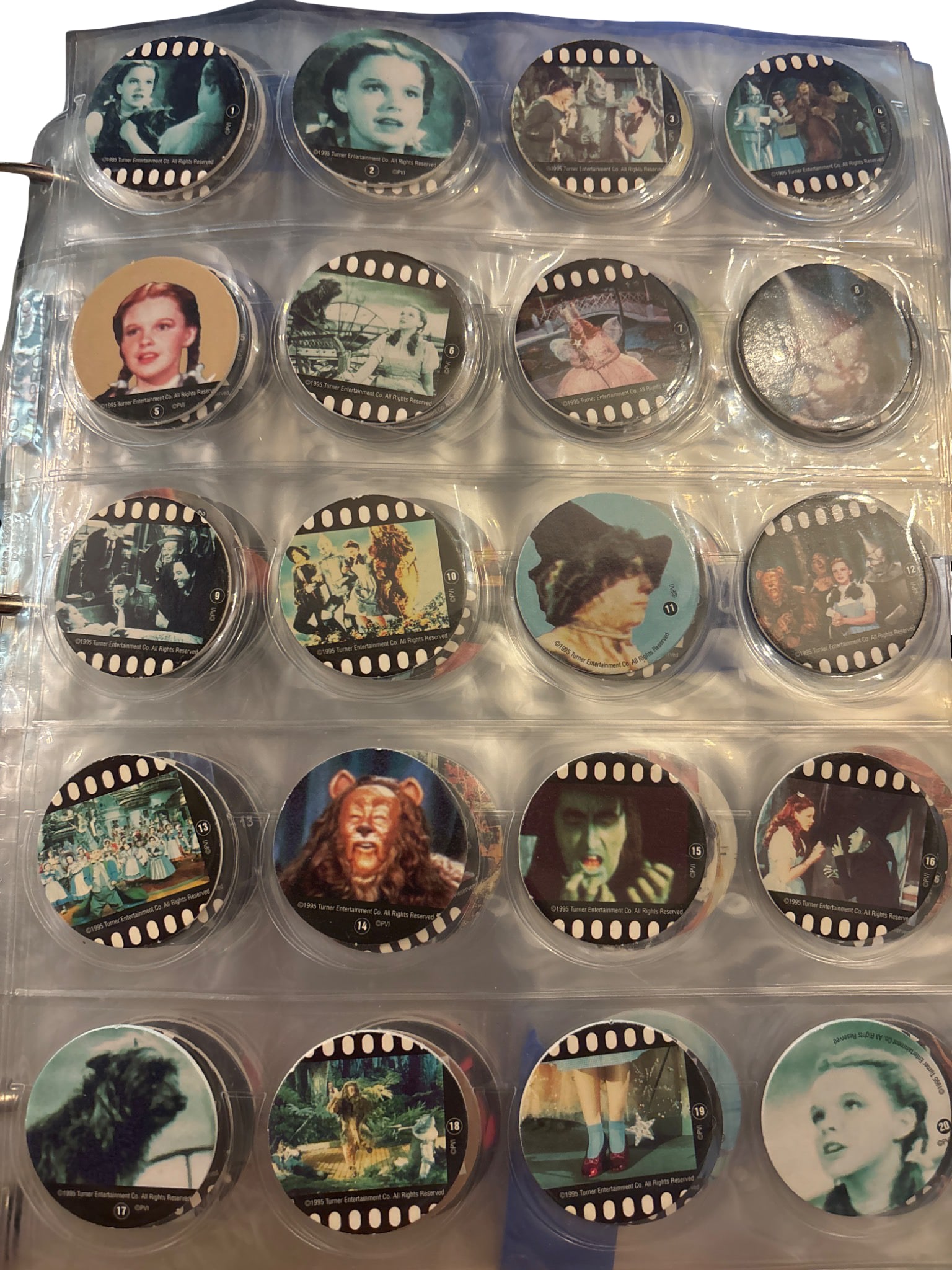 Wizard of Oz Pog Set (#1-45, Incomplete) in Binder Sleeves: Partial Wizard of Oz pog set featuring numbered designs from #1 through #45, not complete. Includes a variety of images depicting scenes and characters from the classic film. Stored in transparent