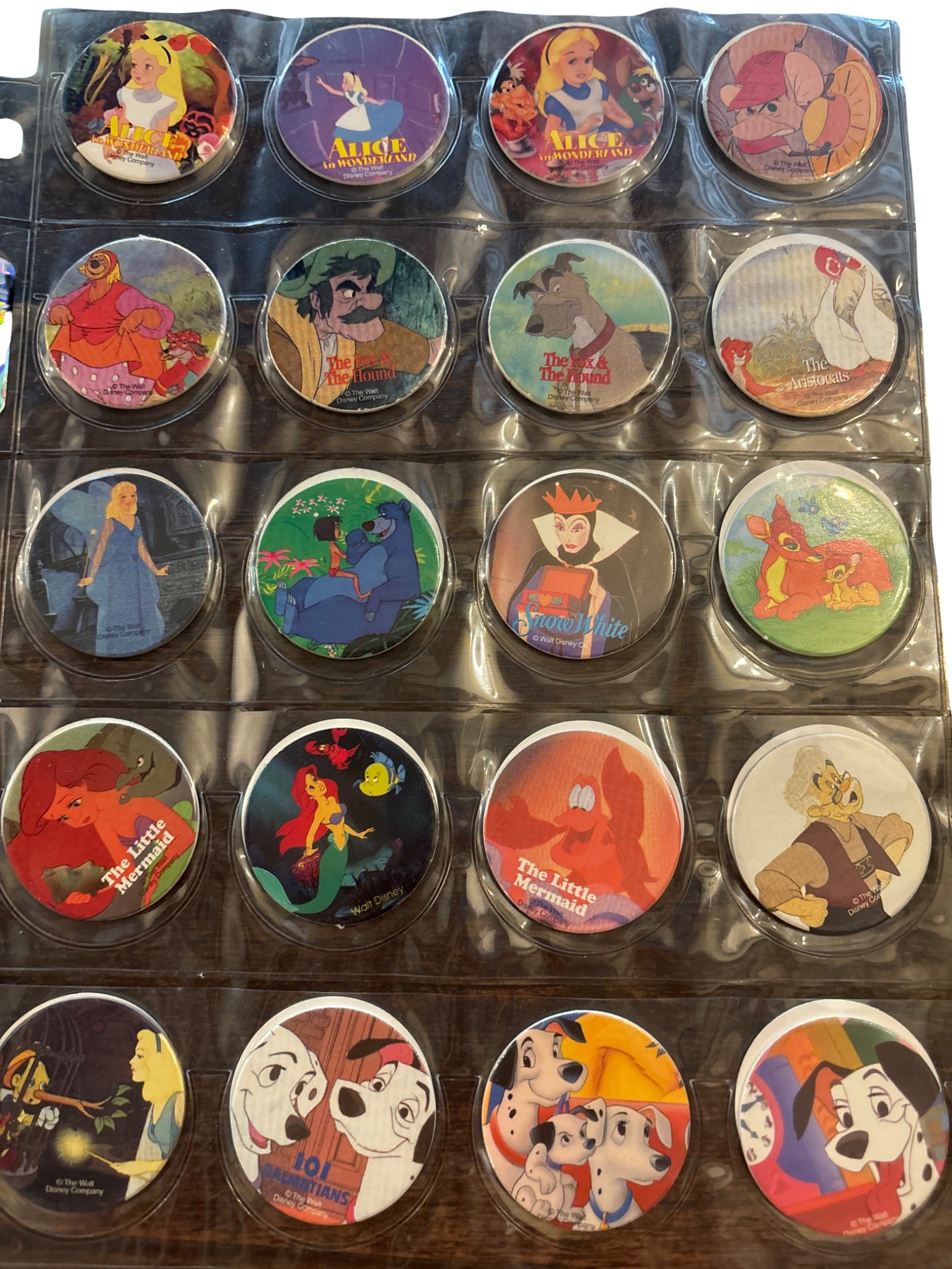 Complete Set of Pog 1-65 Featuring Disney Characters: A complete collection of Pogs numbered 1 through 65, featuring colorful designs of various Disney characters. Includes characters from classic films such as Aladdin, The Little Mermaid, Dumbo, and man