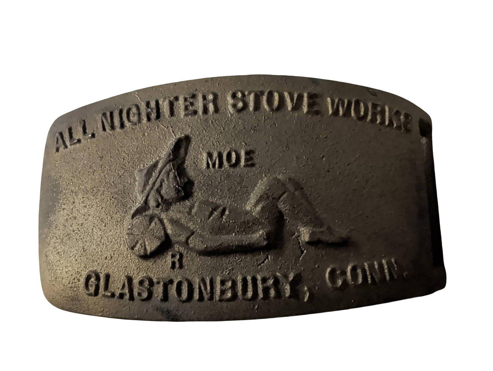 Cast Iron Felt Buckle, 5 in x 2.5 in, All Nighter Stove Works, Glastonbury, Conn.: Rectangular cast iron felt buckle measuring 5 inches by 2.5 inches, featuring embossed text, 'All Nighter Stove Works, Glastonbury, Conn.,' and a figure in relief. The reverse side includes a flat bac