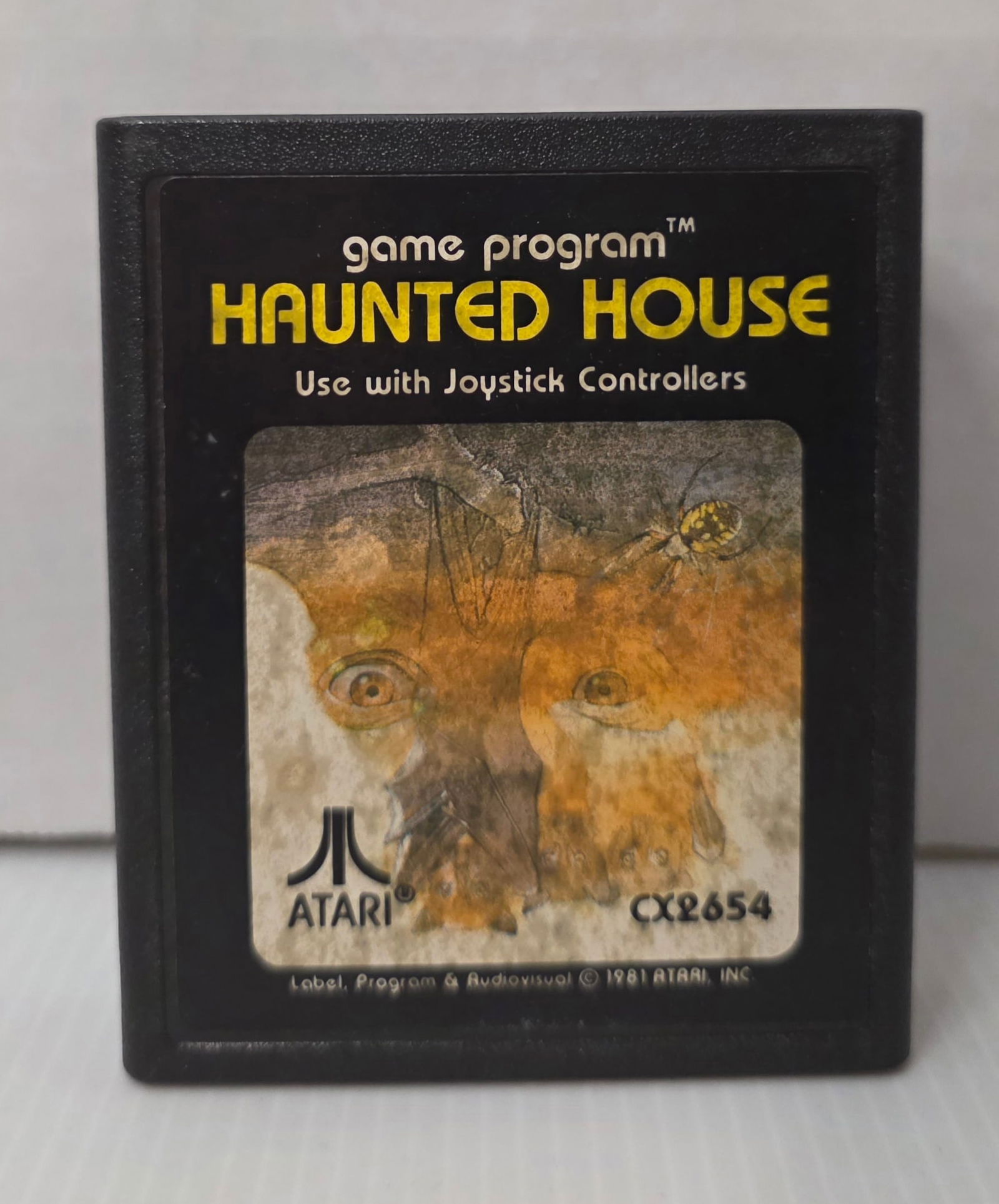 Atari 2600 Haunted House CX-2654: Standalone Haunted House cartridge. Label wear visible. Sold as collectible vintage game.