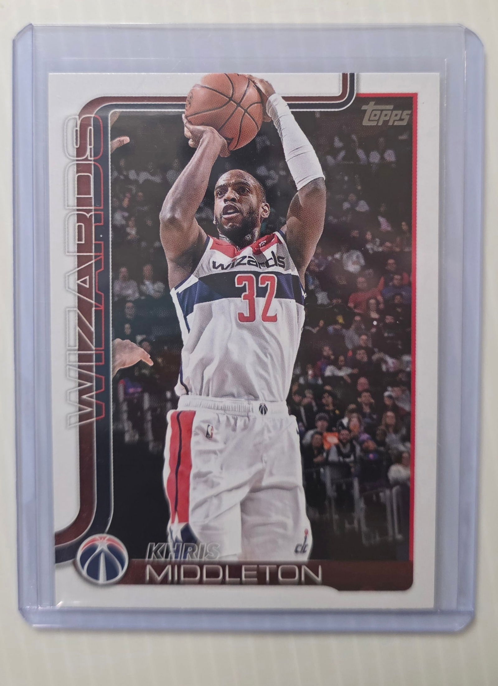 2025 Topps Flagship Khris Middleton #100 Washington Wizards NBA Basketball Card: This is a 2025 Topps Flagship Khris Middleton #100 Washington Wizards NBA basketball trading card, not graded, shown in a protective sleeve/top loader, with condition based on visual inspection only s