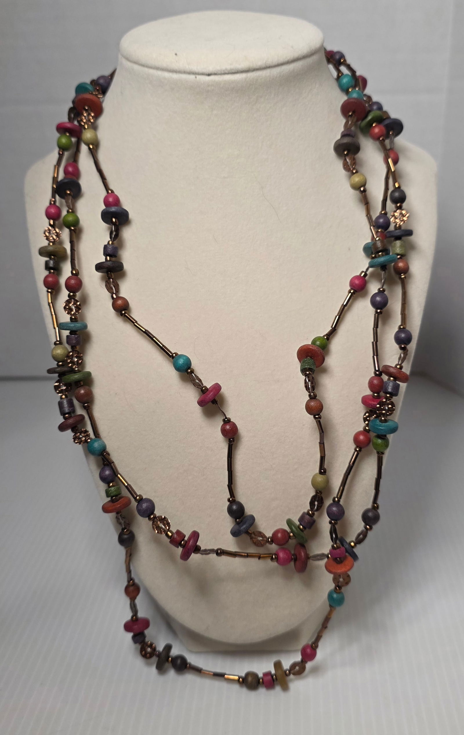 Caracol Long Strand Wrap Necklace Colorful Wood Bead Boho Statement: Caracol brand long single strand wrap necklace featuring colorful mixed wood and plastic beads in a bohemian design. Includes assorted round, disc, and tubular beads in vibrant tones with bronze tone