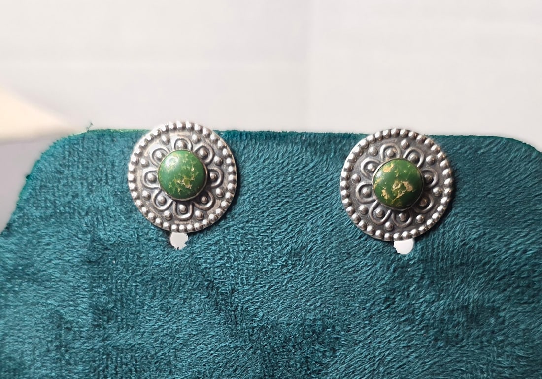 Vintage Sterling Silver Green Turquoise Button Earrings Screw Back: Vintage earrings crafted in marked sterling silver featuring round green veined turquoise stones in decorative button design settings. Screw back clip on style. Marked sterling on reverse. Measure app