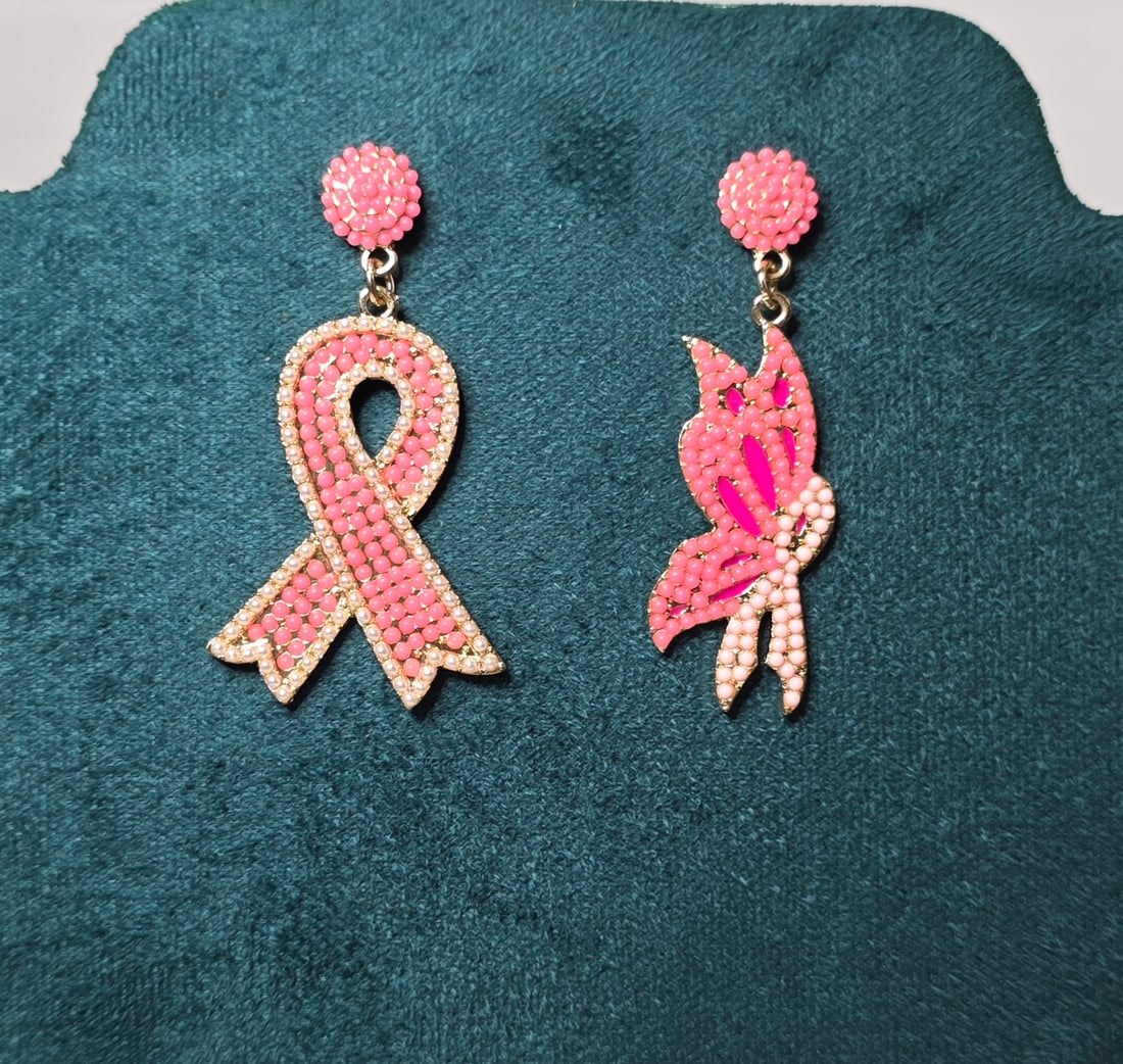 Breast Cancer Awareness Pink Ribbon Earrings Beaded Rhinestone Drop Dangle: Breast Cancer Awareness themed drop earrings featuring pink beaded ribbon design with rhinestone accents and butterfly motif symbolizing hope and strength. Gold tone metal with post back closures. Sta