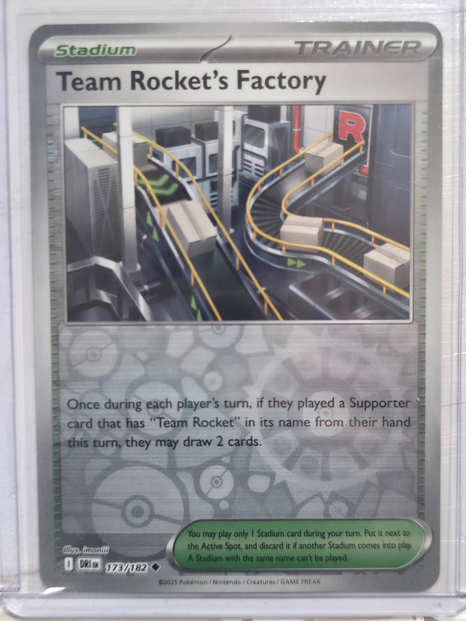 2025 Team Rockets Factory Paradox Rift 173/182 Reverse Holo: Team Rockets Factory Stadium Trainer card. Paradox Rift set. Card number 173/182. Reverse holo uncommon. Illustrated by imomiii. 2025 Pokemon Nintendo Creatures GAME FREAK. Pre EN print. Preowned card