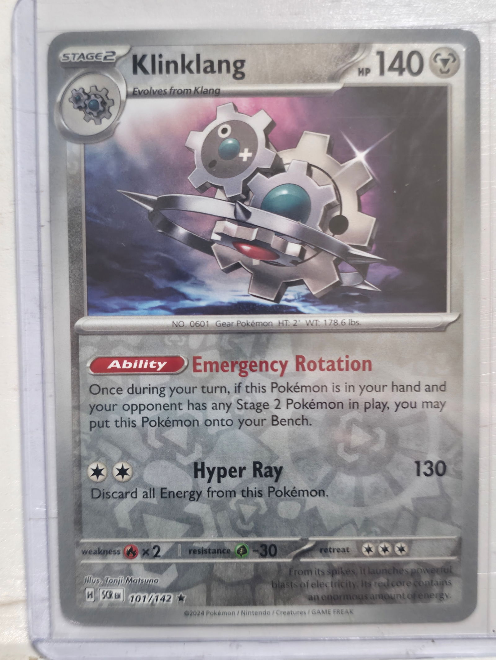 2024 Klinklang Stellar Crown 101/142 Rare: 2024 Klinklang Stage 2 Metal Pokemon. Evolves from Klang. Stellar Crown set. Card number 101/142. Rare non holo. HP 140. Ability Emergency Rotation. Attack Hyper Ray 130. Illustrated by Tonji Matsuno.