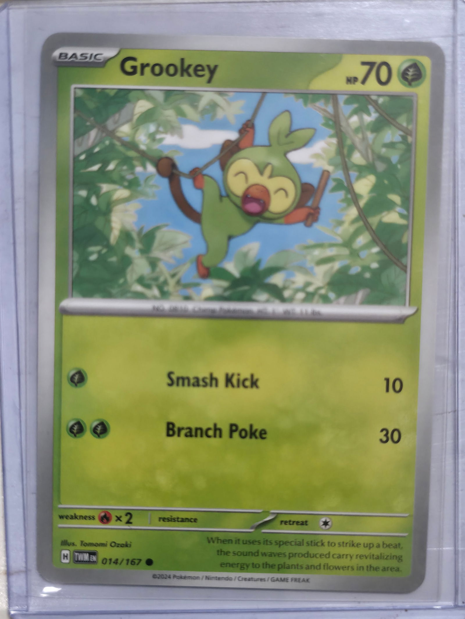 2024 Grookey Twilight Masquerade 014/167: 2024 Grookey Basic Grass Pokemon. Twilight Masquerade set. Card number 014/167. HP 70. Attacks Smash Kick 10 and Branch Poke 30. Illustrated by Tomomi Ozaki. Regulation mark H. Non holo. Preowned