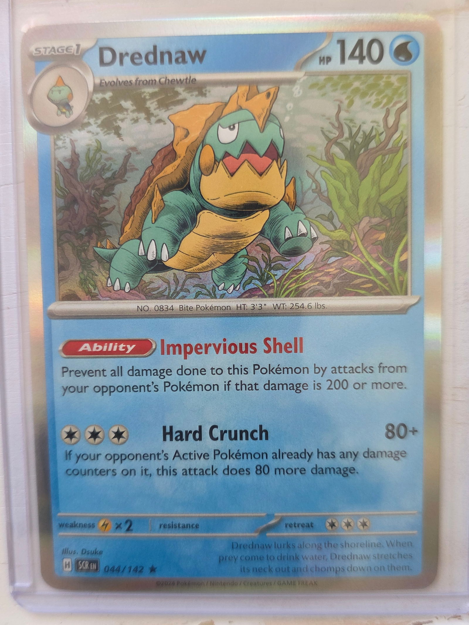 2024 Drednaw SV Base 044/142 Holo Rare: 2024 Drednaw Stage 1 Water type Pokemon. Evolves from Chewtle. Scarlet and Violet Base set. Card number 044/142. HP 140. Ability Impervious Shell. Attack Hard Crunch 80+. Holo foil card front. Preowne