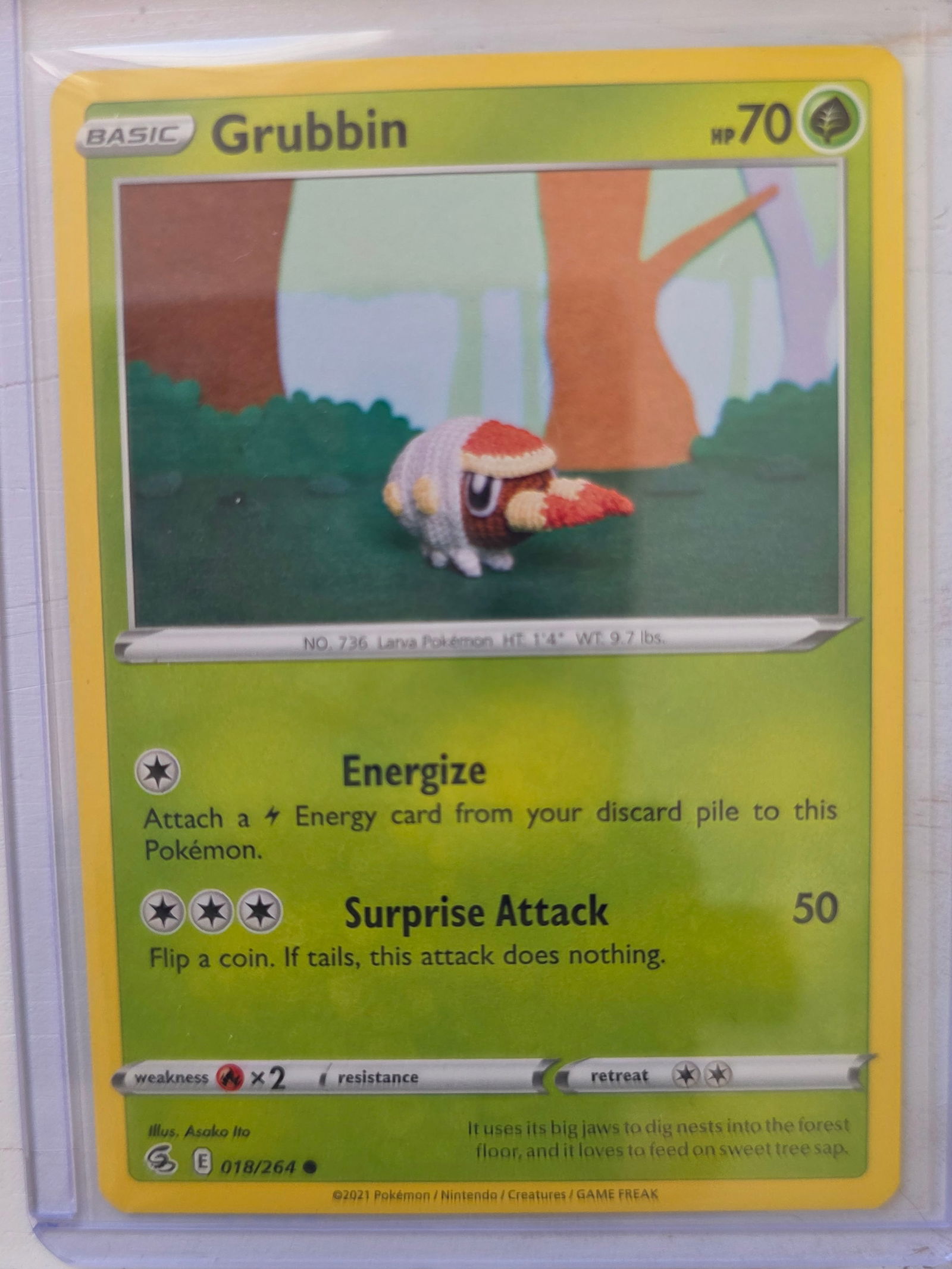 2021 Grubbin Fusion Strike 018/264: 2021 Grubbin Basic Grass type Pokemon. Fusion Strike set. Card number 018/264. HP 70. Attacks Energize and Surprise Attack 50. Illustrated by Asako Ito. Non holo common card. Preowned card stored in p