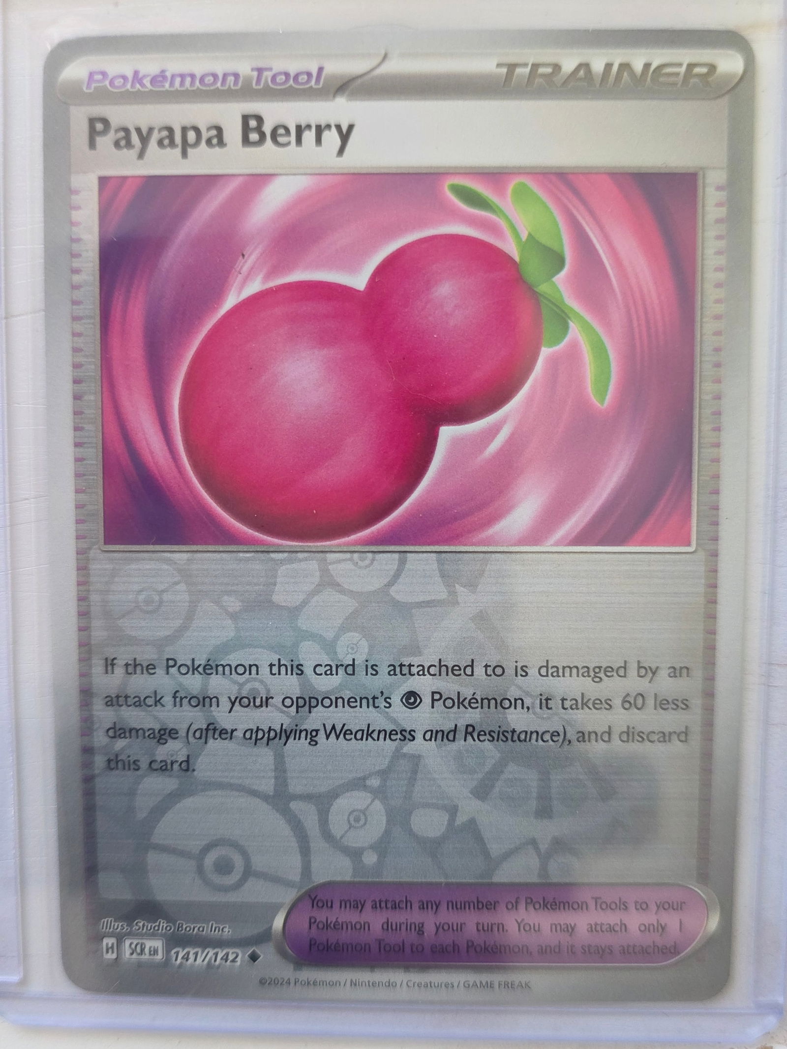 2024 Payapa Berry 141/142 Reverse Holo: 2024 Payapa Berry Trainer Pokemon Tool card 141/142. Reverse holo foil pattern across card surface with non holo artwork box. Preowned card stored in penny sleeve and top loader. Sold as shown.
