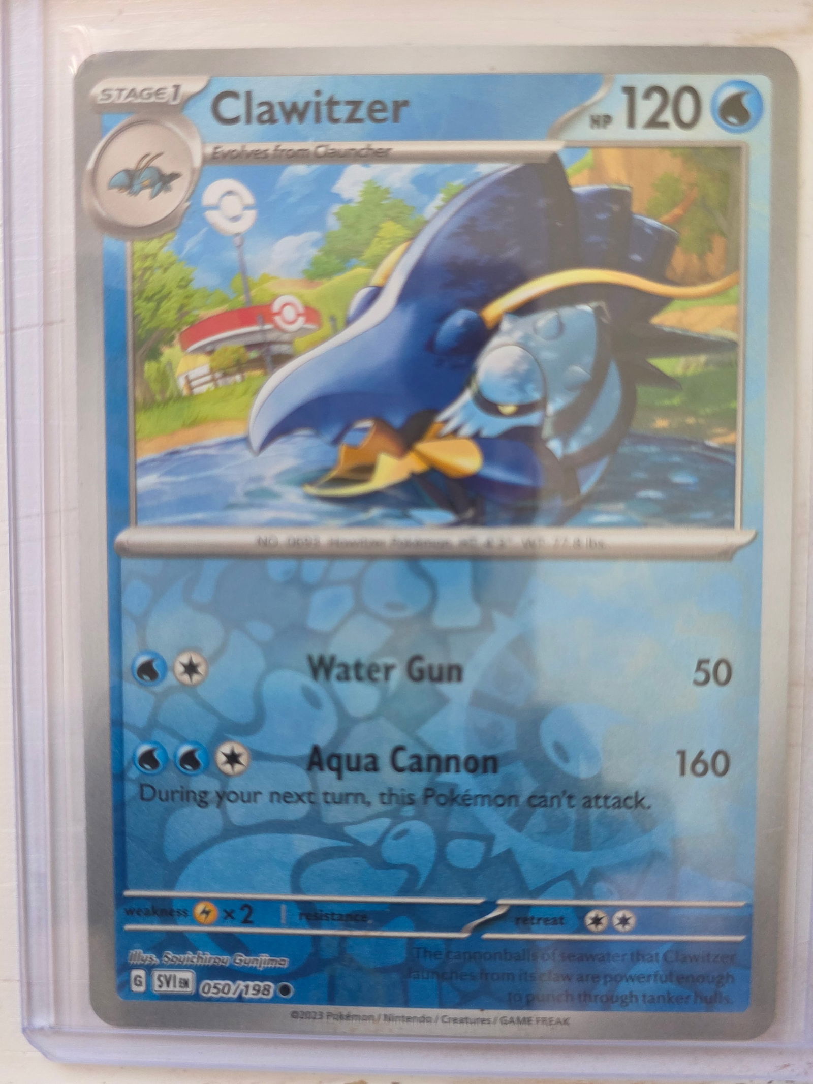 2023 Clawitzer 050/198 Reverse Holo: 2023 Clawitzer Stage 1 card 050/198 evolving from Clauncher. 120 HP Water type. Reverse holo foil pattern across card surface with non holo artwork box. Water Gun 50. Aqua Cannon 160. Preowned card st