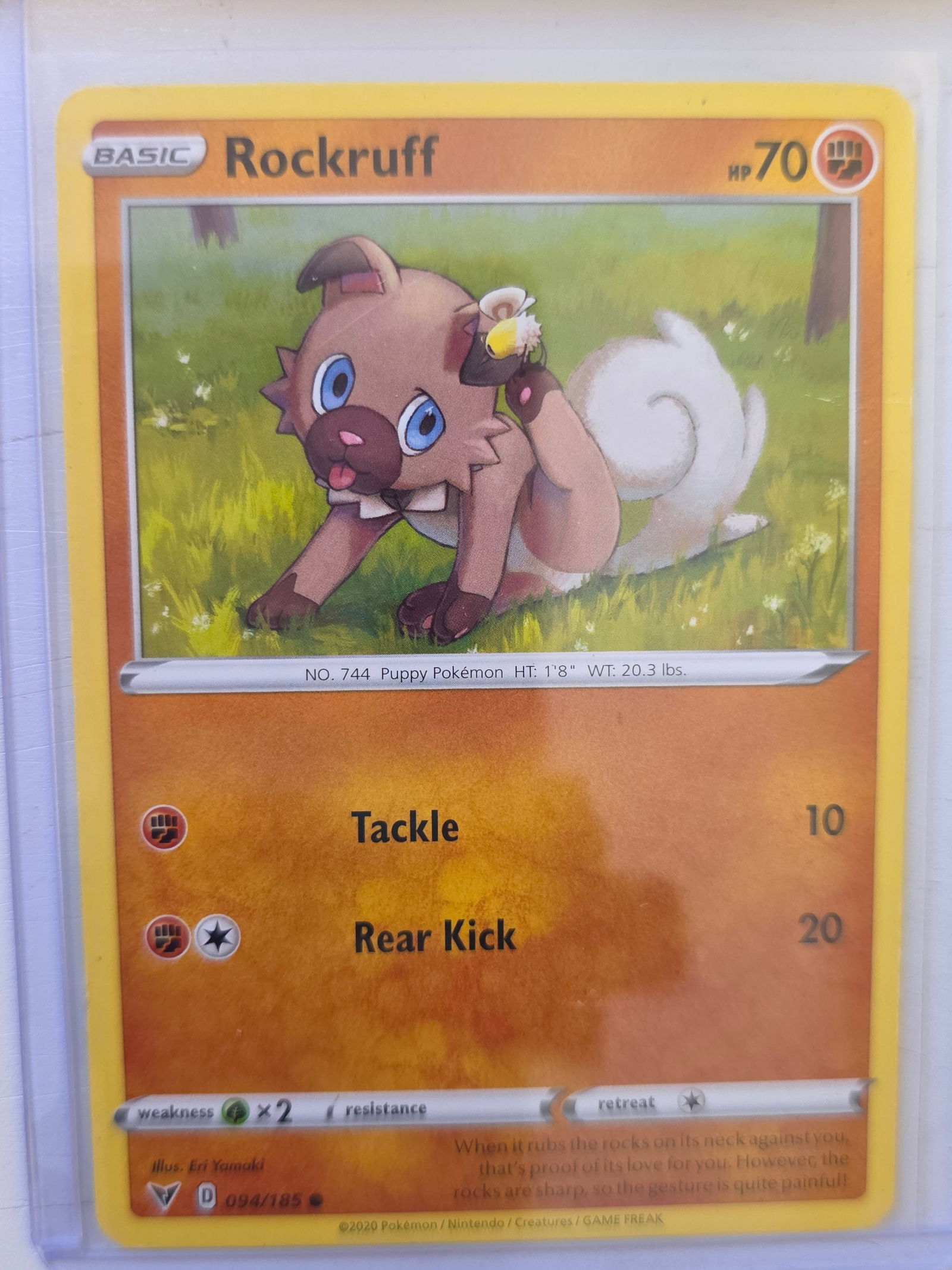 2020 Rockruff Vivid Voltage 094/185 Pokemon Card: 2020 Pokemon Rockruff card numbered 094/185 from the Sword & Shield Vivid Voltage expansion set. Illustrated by Eri Yamaki. Fighting type basic Pokemon card. Card stored in penny sleeve and top loader