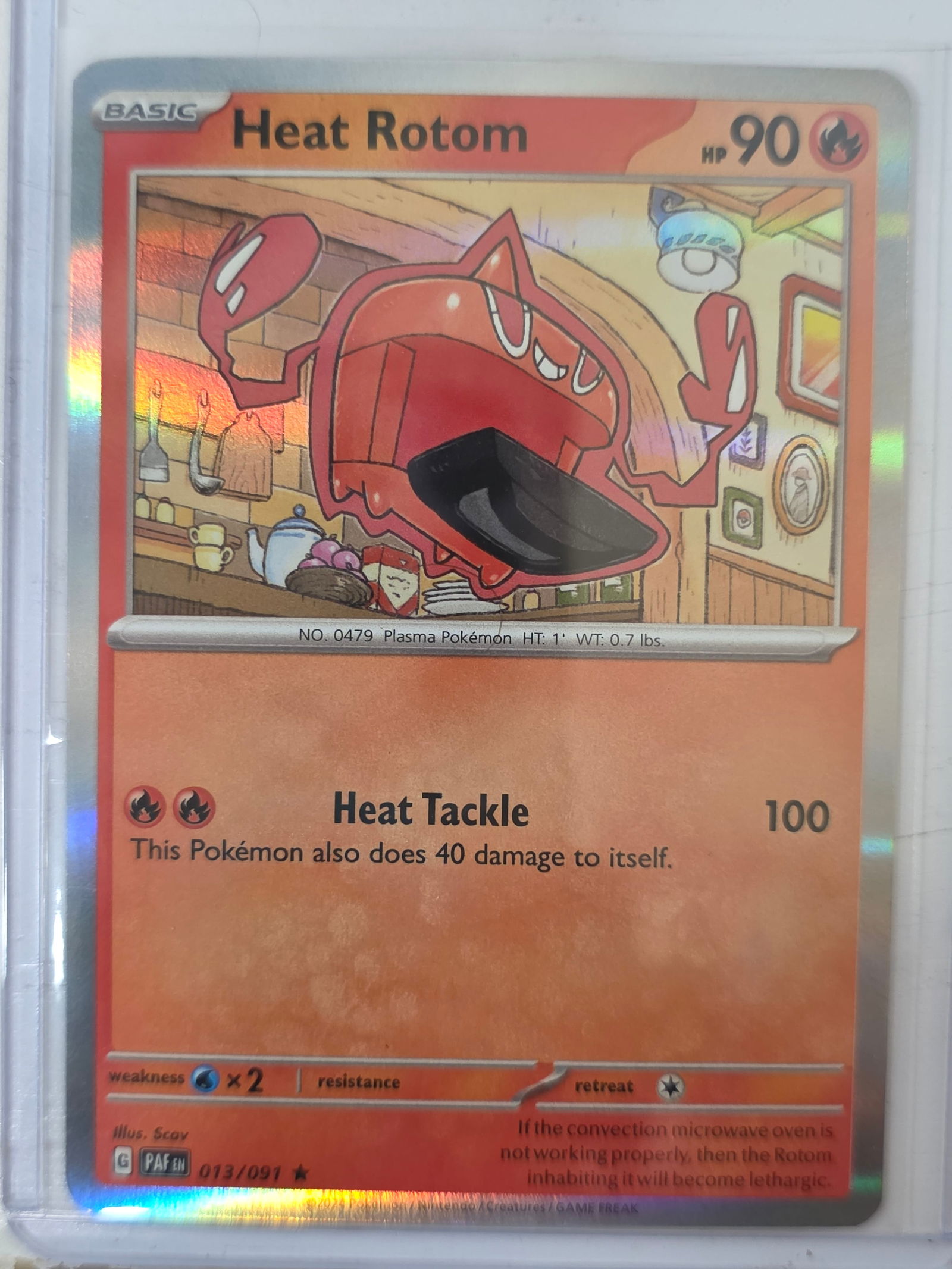2024 Heat Rotom Paldean Fates 013/091 Holo Pokemon Card: 2024 Pokemon Heat Rotom holographic card numbered 013/091 from the Scarlet & Violet Paldean Fates expansion set. Illustrated by Scav. Standard holographic finish across the illustration area. Card sto