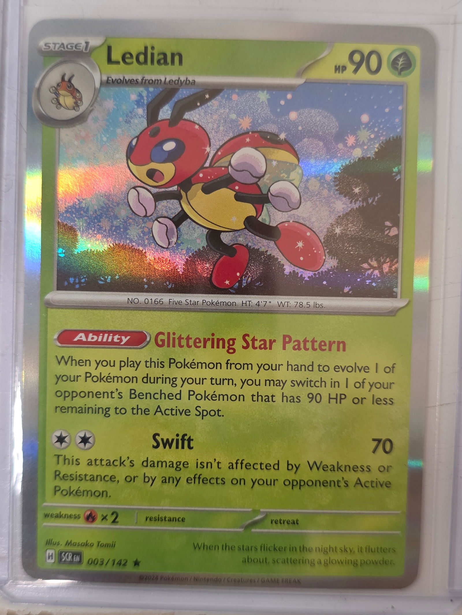 2024 Ledian Stellar Crown 003/142 Holo Pokemon Card: 2024 Pokemon Ledian holographic card numbered 003/142 from the Scarlet & Violet Stellar Crown expansion set. Illustrated by Masako Tomii. Standard holographic rare finish across the illustration area.