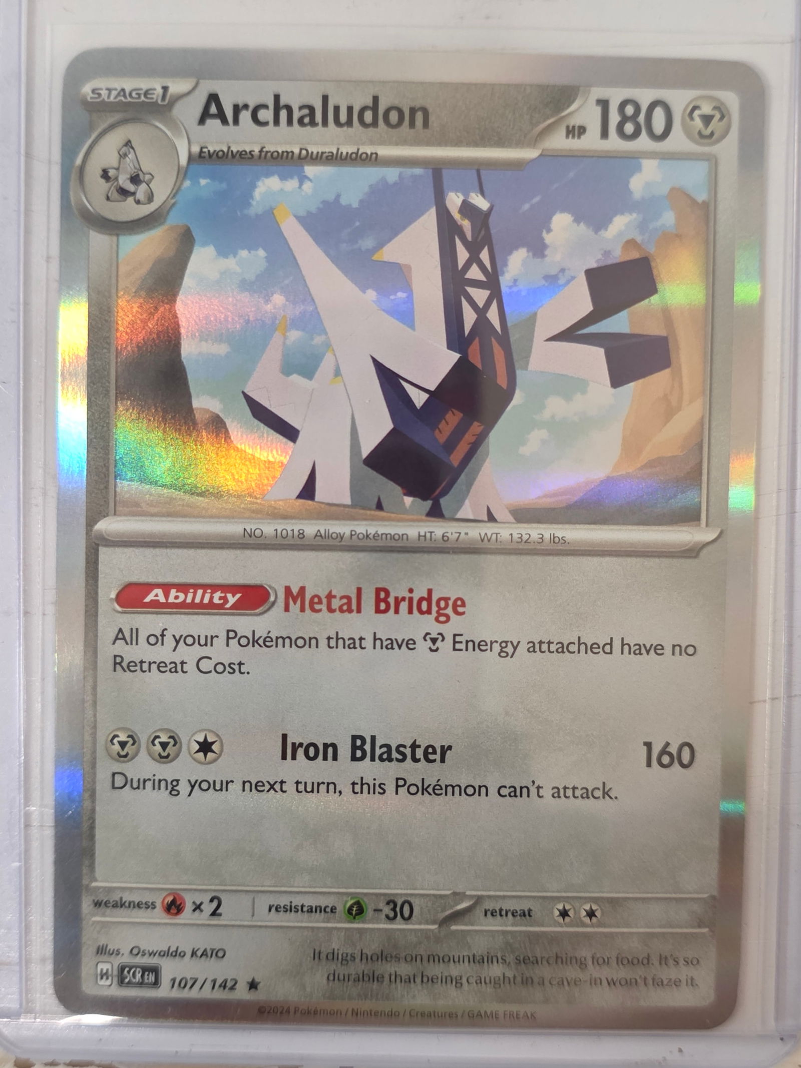 2024 Archaludon Stellar Crown 107/142 Holo Pokemon Card: 2024 Pokemon Archaludon holographic card numbered 107/142 from the Scarlet & Violet Stellar Crown expansion set. Illustrated by Oswaldo KATO. Standard holographic finish across the illustration area.