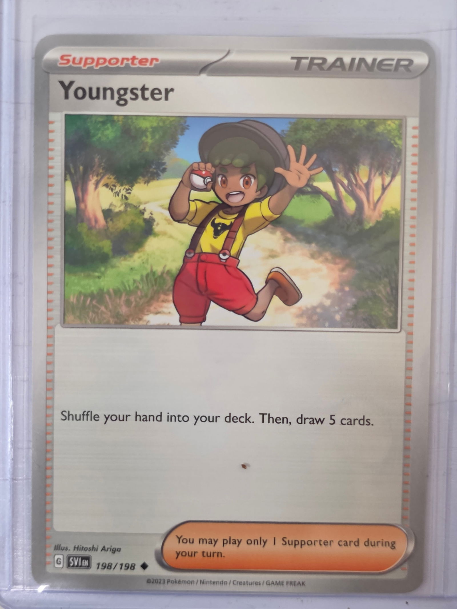 2023 Youngster Scarlet & Violet 198/198 Trainer Pokemon Card: 2023 Pokemon Trainer Supporter Youngster card numbered 198/198 from the Scarlet & Violet base expansion set. Illustrated by Hitoshi Ariga. Standard non-holographic trainer card finish. Card stored in