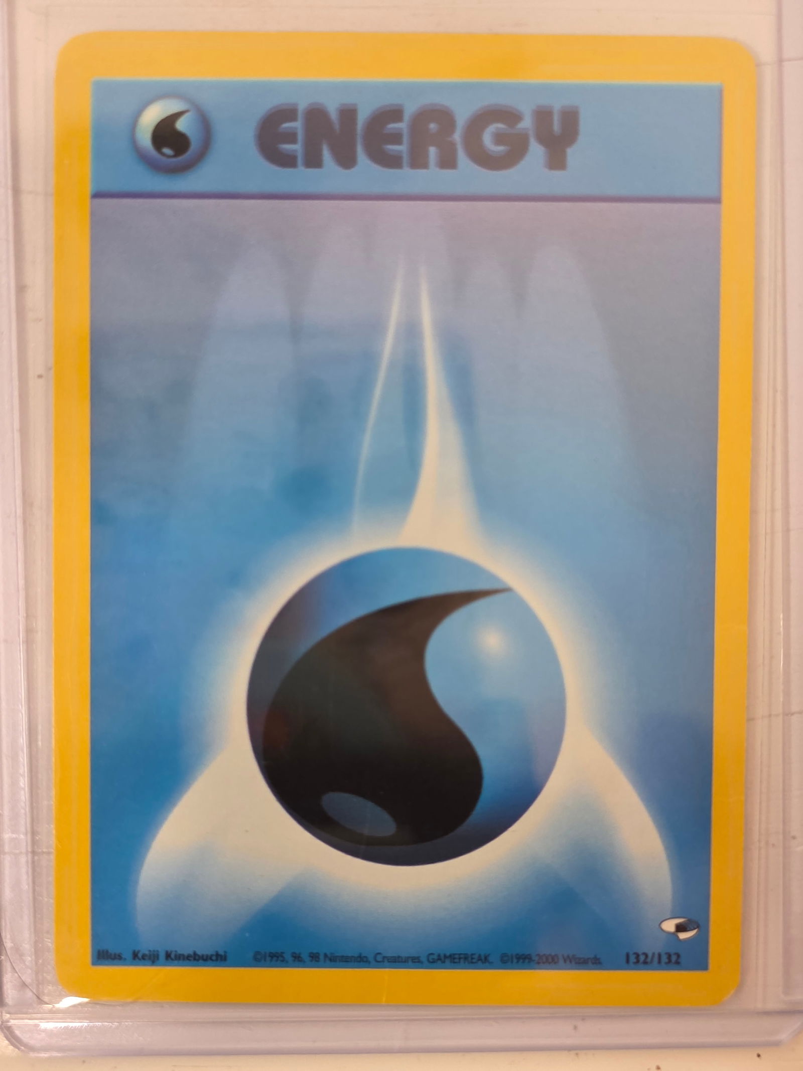 1999 Water Energy Base Set 132/132: 1999 Pokemon Water Energy card numbered 132/132 from the original Base Set expansion. Card stored in penny sleeve and top loader.