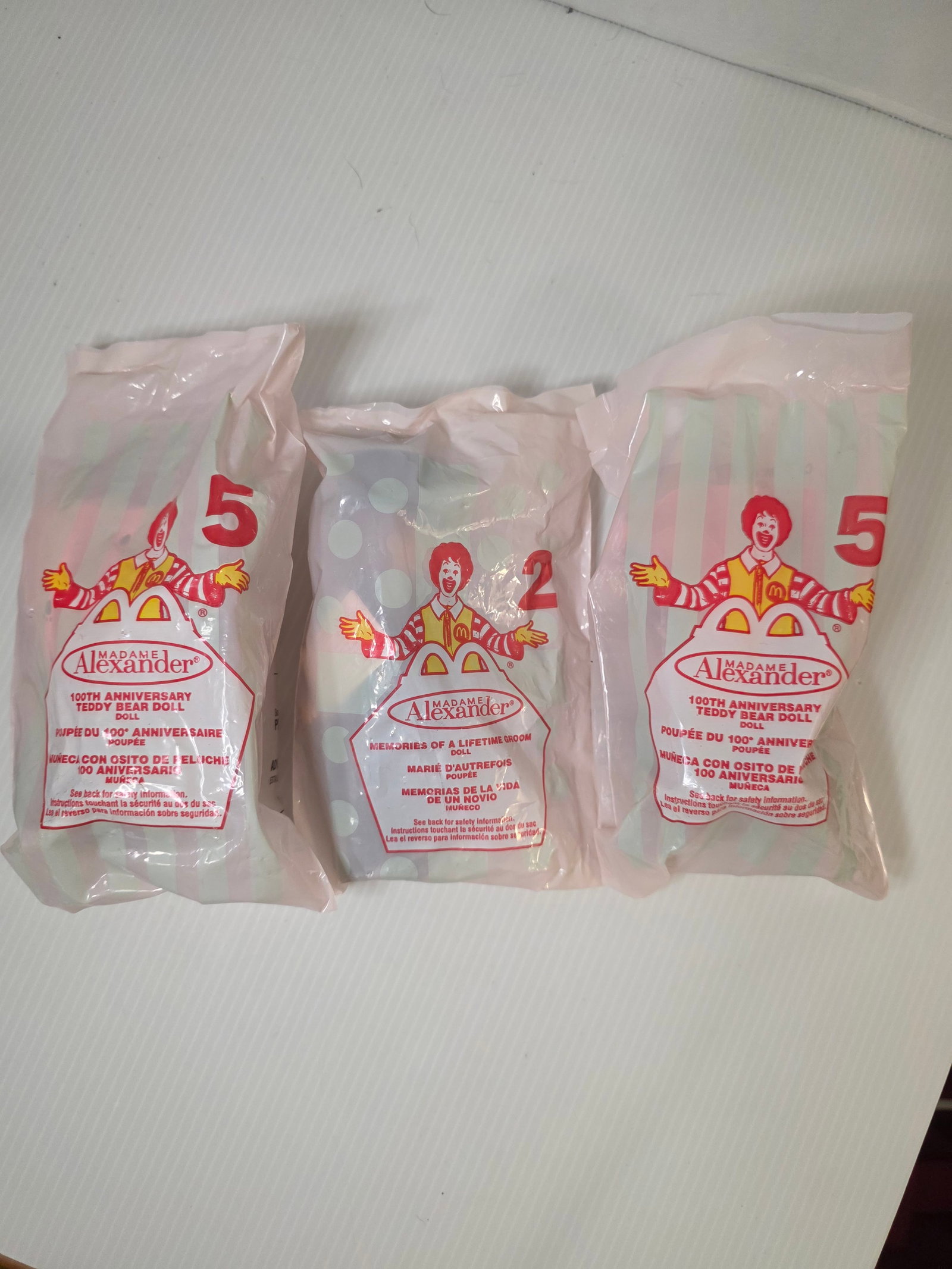 2002 McDonalds Madame Alexander Dolls Sealed Toy Lot: Group of sealed McDonald's Madame Alexander Happy Meal dolls issued in 2002 celebrating the Madame Alexander 100th Anniversary Teddy Bear Doll series.This lot includes three factory sealed toys, still
