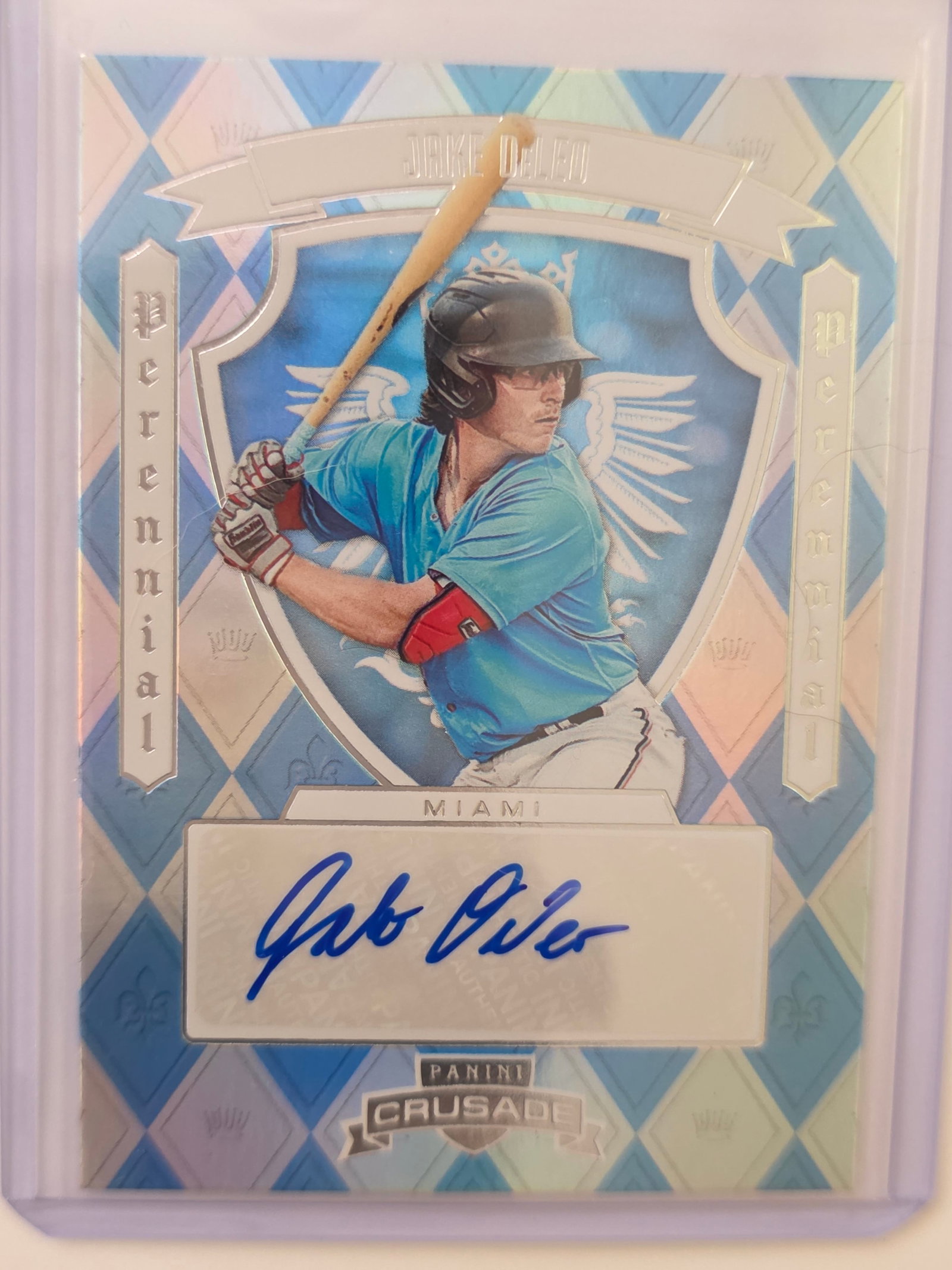 Panini Crusade Jake DeLeo Perennial Auto Miami: 2025 Panini Crusade Jake DeLeo Perennial autograph card featuring Miami prospect. Blue patterned Crusade design with bold blue ink autograph. Autograph is guaranteed by Panini. Clean modern card with