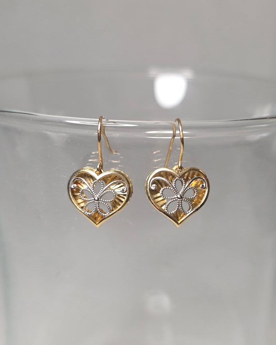 14K Two Tone Gold Heart Dangle Earrings Filigree Floral Hook Back: Previously owned pair of 14K two tone solid gold heart dangle earrings. The design features yellow gold with white gold floral accent detail and filigree styling. Both earrings are marked 14K on the r