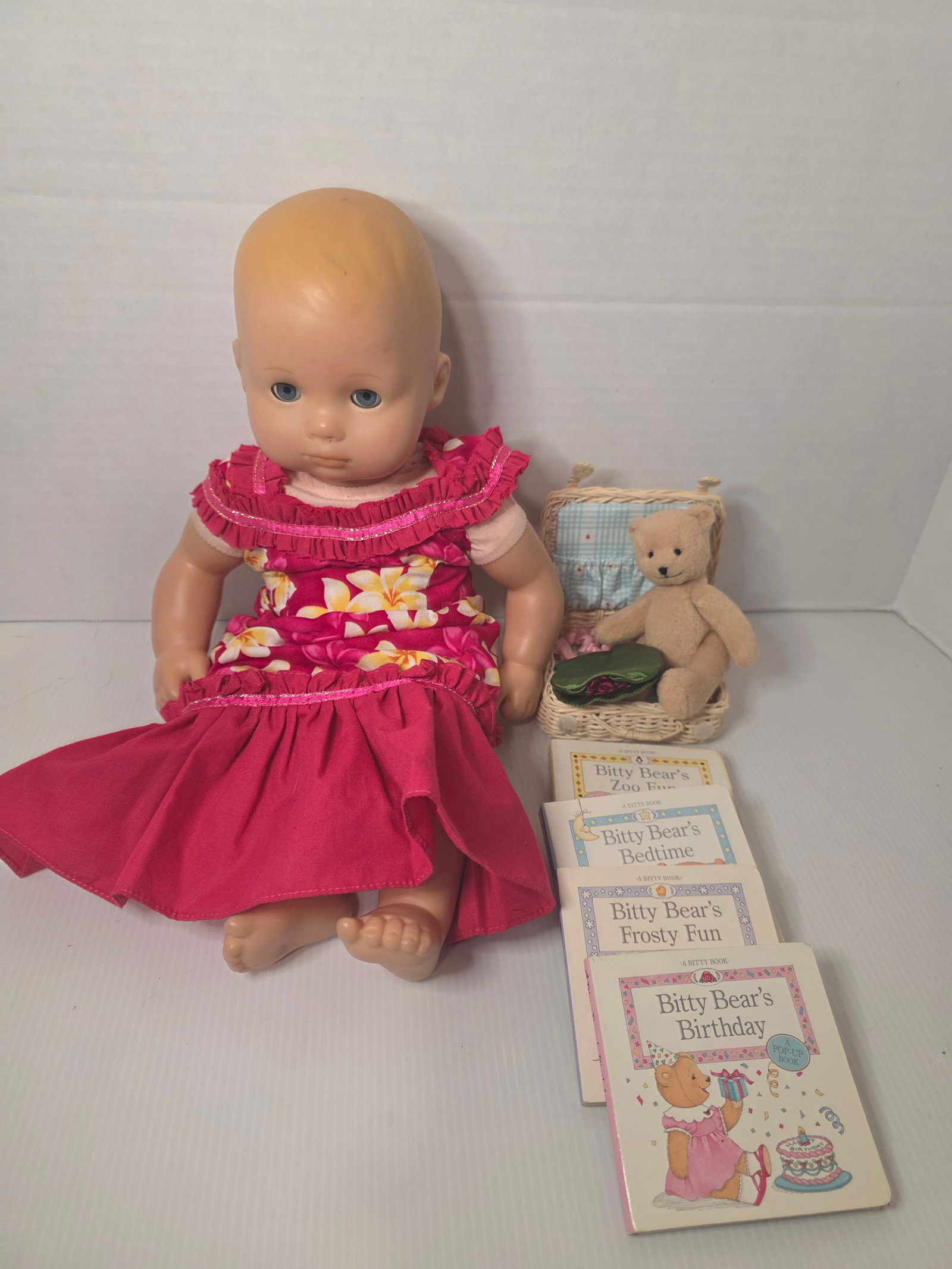 American Girl Bitty Baby Doll Lot Basket Bear Books Pleasant Company: American Girl Bitty Baby doll lot with accessories and books. The lot includes a 15 inch Bitty Baby doll with molded vinyl head and cloth body, marked American Girl on the back of the neck. The doll h
