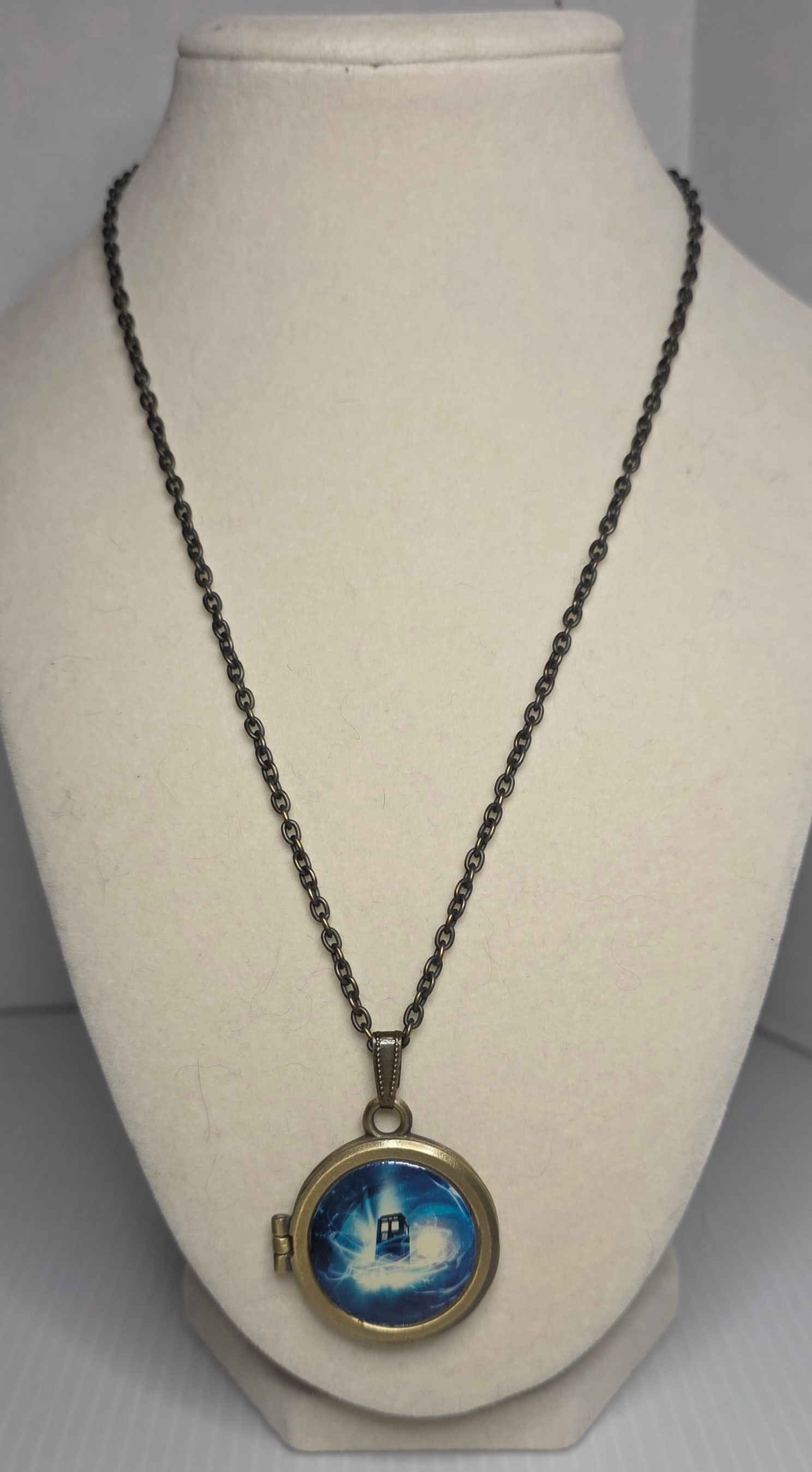 Doctor Who TARDIS Locket Necklace BBC Keep Calm Call The Doctor: Doctor Who licensed BBC TARDIS locket pendant necklace featuring a round hinged design with magnetic closure. The interior is engraved with Keep Calm and Call The Doctor and includes a TARDIS image in