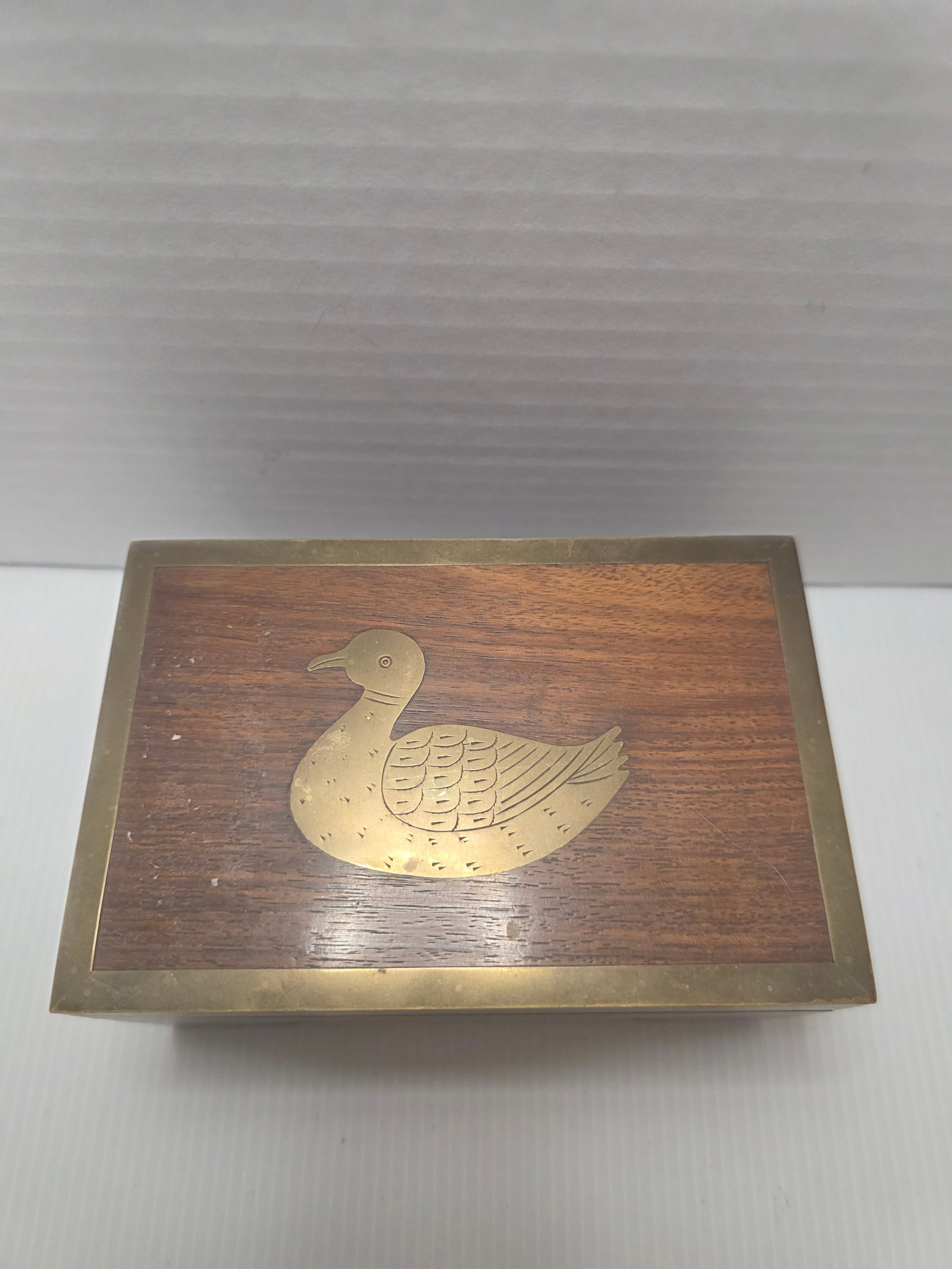 Vintage Schmid Music Box Wood Duck Inlay Sankyo Japan Wind Up: Vintage Schmid wooden music box featuring a brass duck inlay on the lid. The interior contains a wind up Sankyo musical movement and a small storage compartment.The base is marked Schmid, indicating m