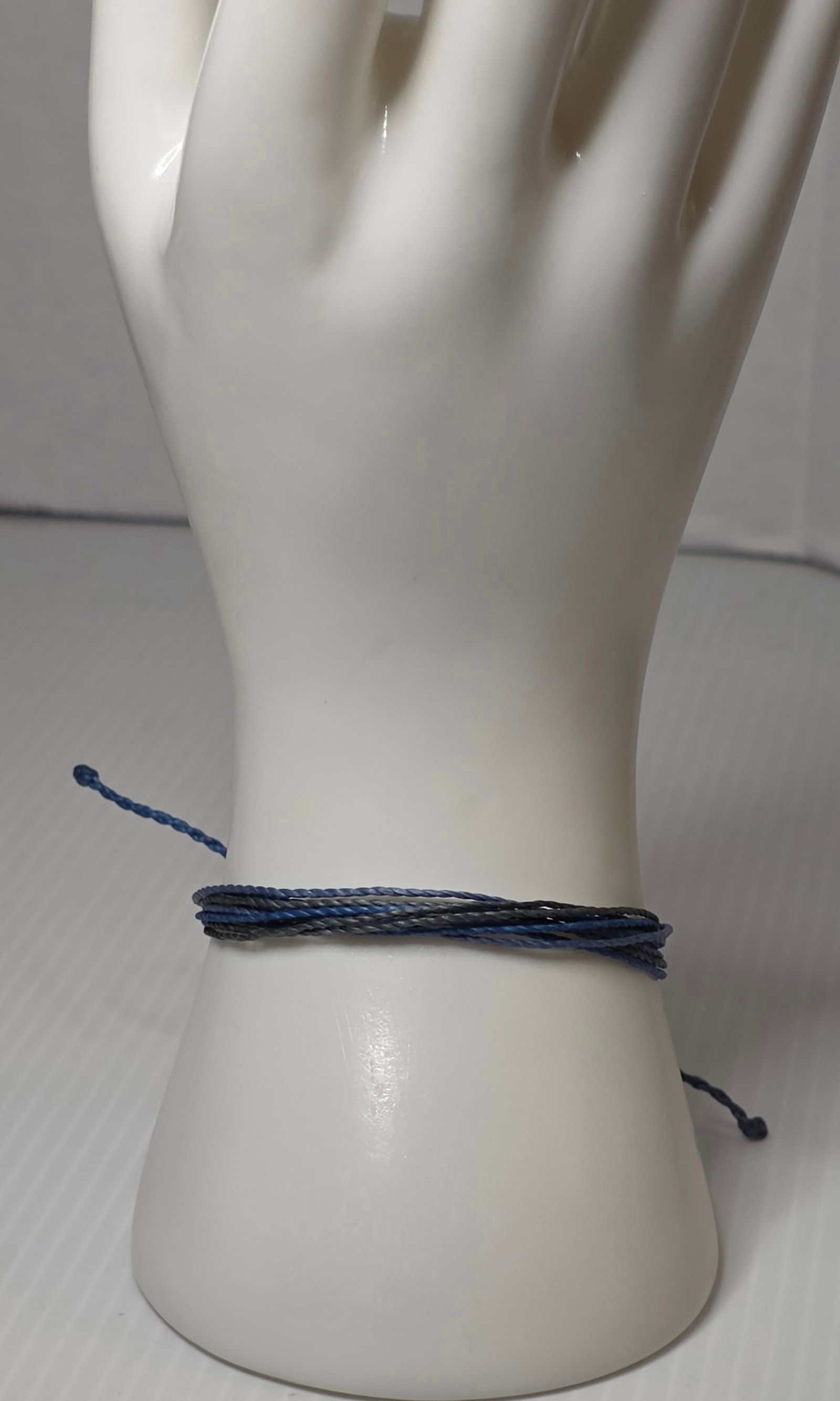 Pura Vida Blue Braided Bracelet Adjustable Cord Beach Surf Style: Authentic Pura Vida braided cord bracelet featuring multi tone blue strands with an adjustable sliding knot closure. The bracelet has a silver tone Pura Vida logo charm attached.This style is designed