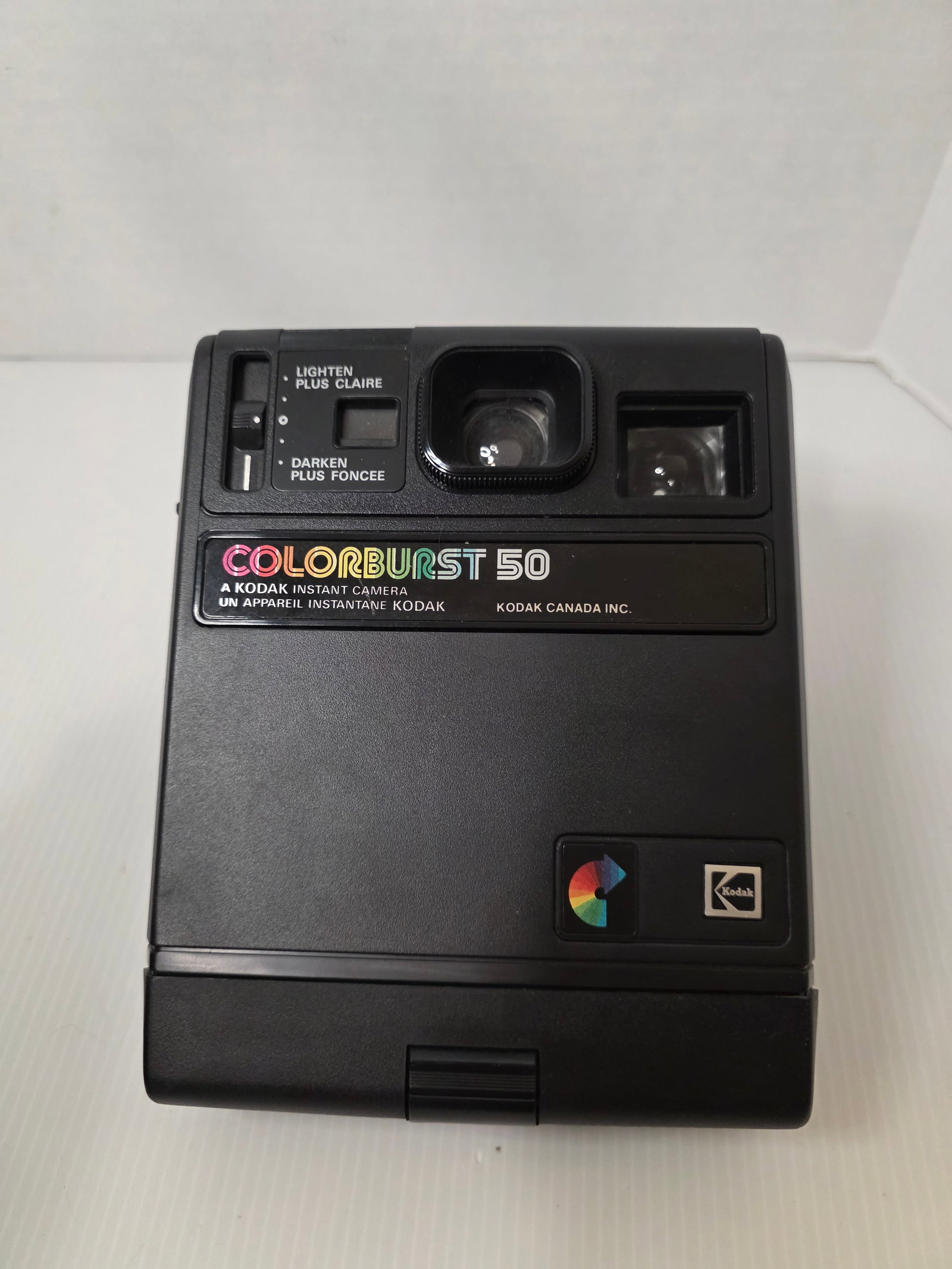 Kodak Colorburst 50 Instant Camera Vintage Kodak Canada: Vintage Kodak Colorburst 50 instant camera produced by Kodak Canada Inc. The camera features a fixed focus lens, built in flash, exposure adjustment slider, and viewfinder.The body is marked Colorburs