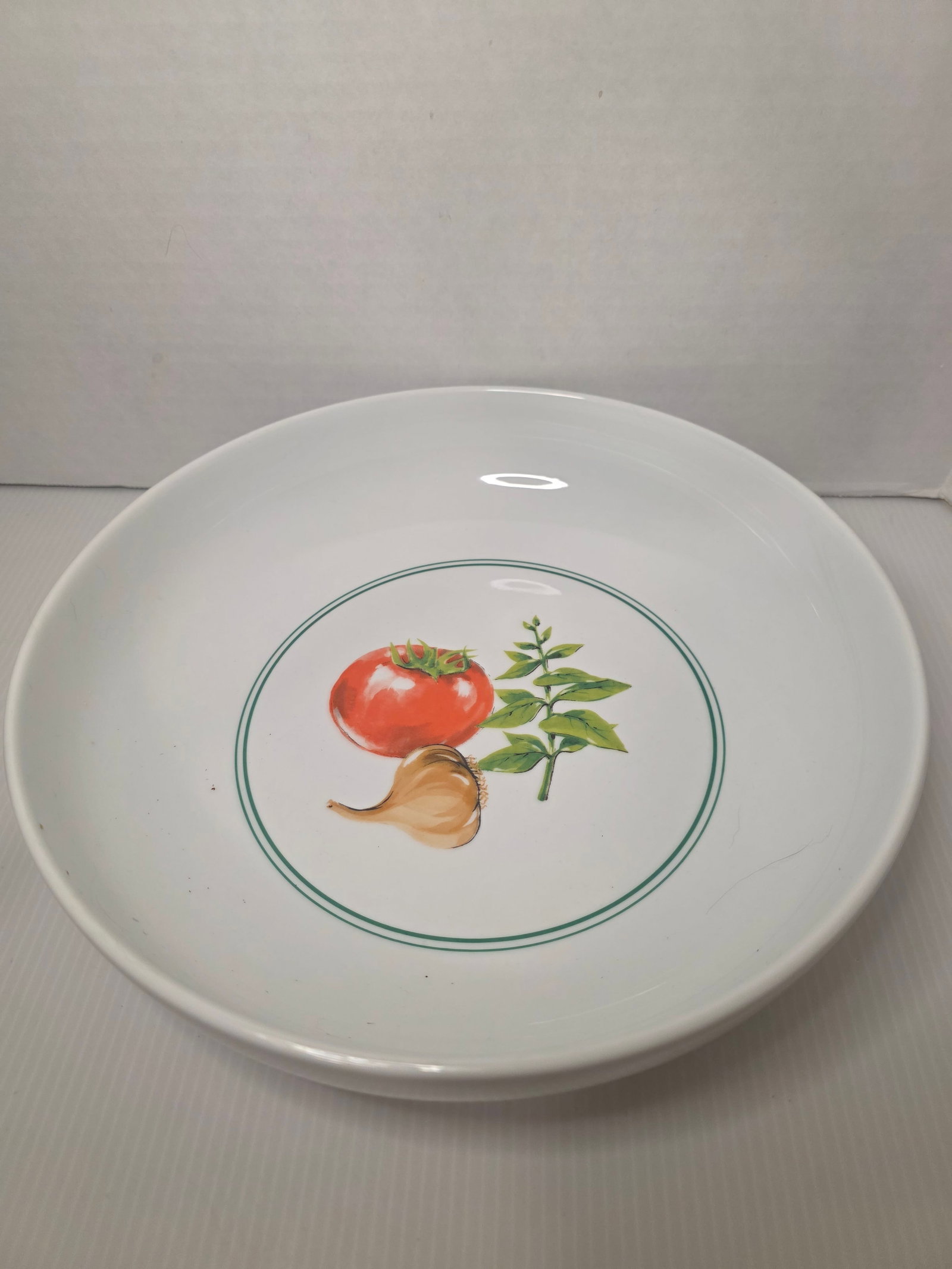 Ragu Rewards Pasta Bowl Tomato Garlic Basil Promo Ceramic Vintage: Vintage Ragu Rewards promotional pasta bowl featuring a white ceramic body with a central design of tomato, garlic, and basil framed by a green ring.The underside is marked Ragu Rewards Made in China.