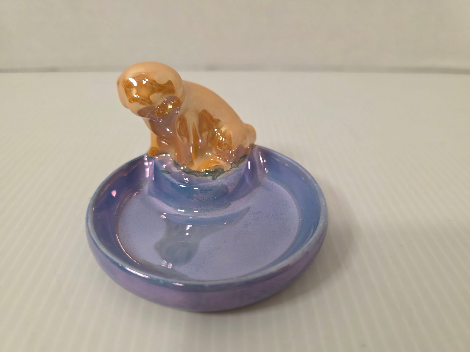 Vintage Japan Ceramic Puppy (or Kitten) Ring Holder / Trinket Dish: Vintage ceramic ring holder featuring a small animal figure, puppy or kitten, on a dish base. Marked Made in Japan on underside.Designed to hold rings or small jewelry items. Glossy glaze with mid-cen