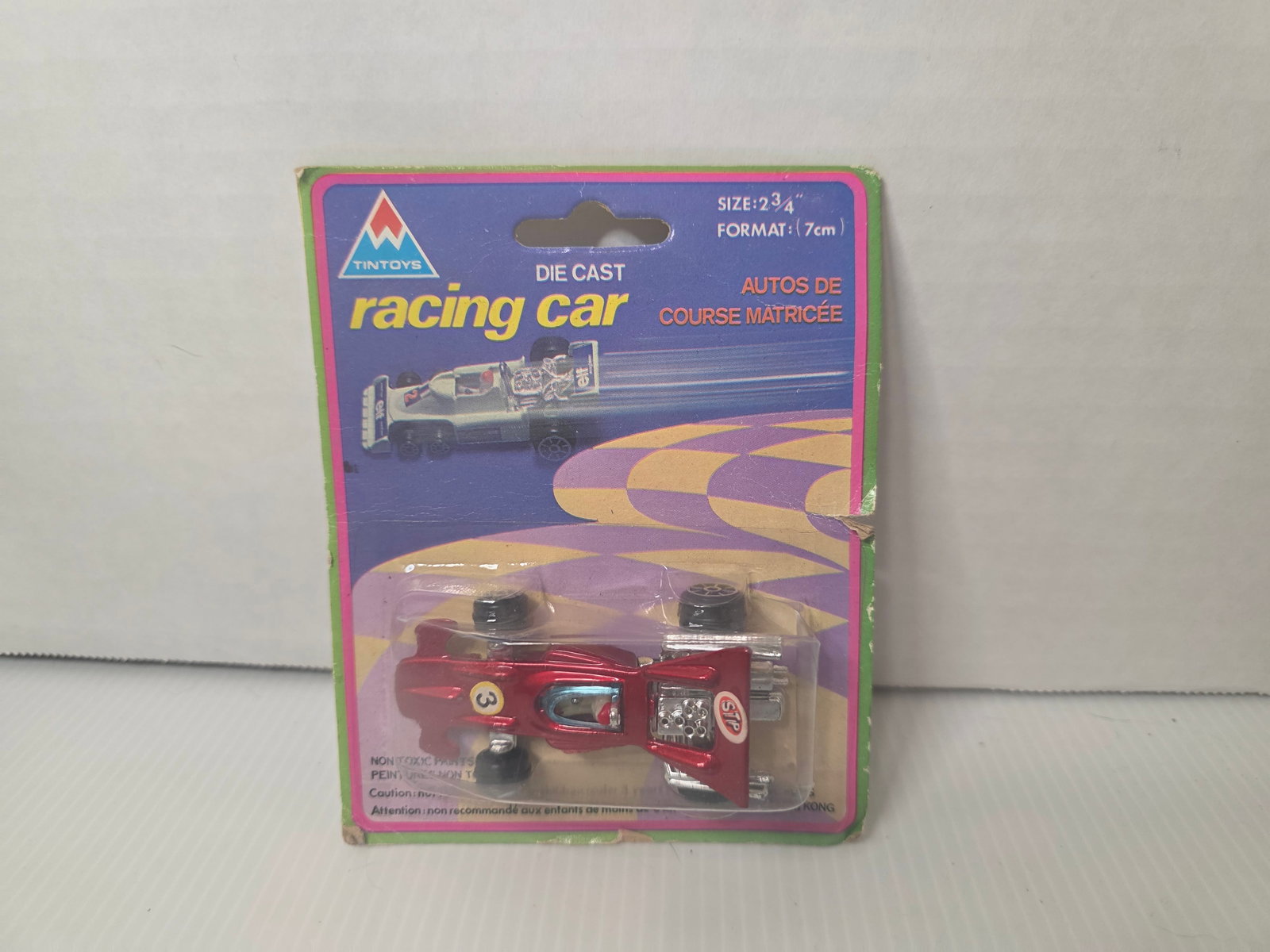 Vintage Tintoys Die Cast Racing Car Sealed Hong Kong F1 Style: Vintage Tintoys die cast racing car in original sealed packaging. 2 3/4 inch Formula 1 style model made in Hong Kong. Card shows multiple model lineup on back. Car remains sealed and appears unused. P