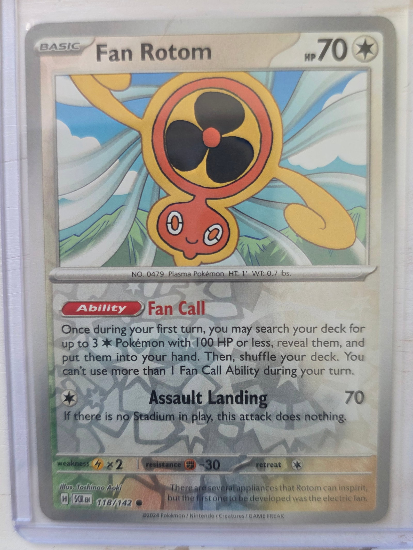 2024 Fan Rotom SV Base 118/142 Reverse Holo: 2024 Fan Rotom Basic Colorless type Pokemon. Scarlet and Violet Base set. Card number 118/142. HP 70. Ability Fan Call. Attack Assault Landing 70. Reverse holo pattern on card front. Preowned card sto
