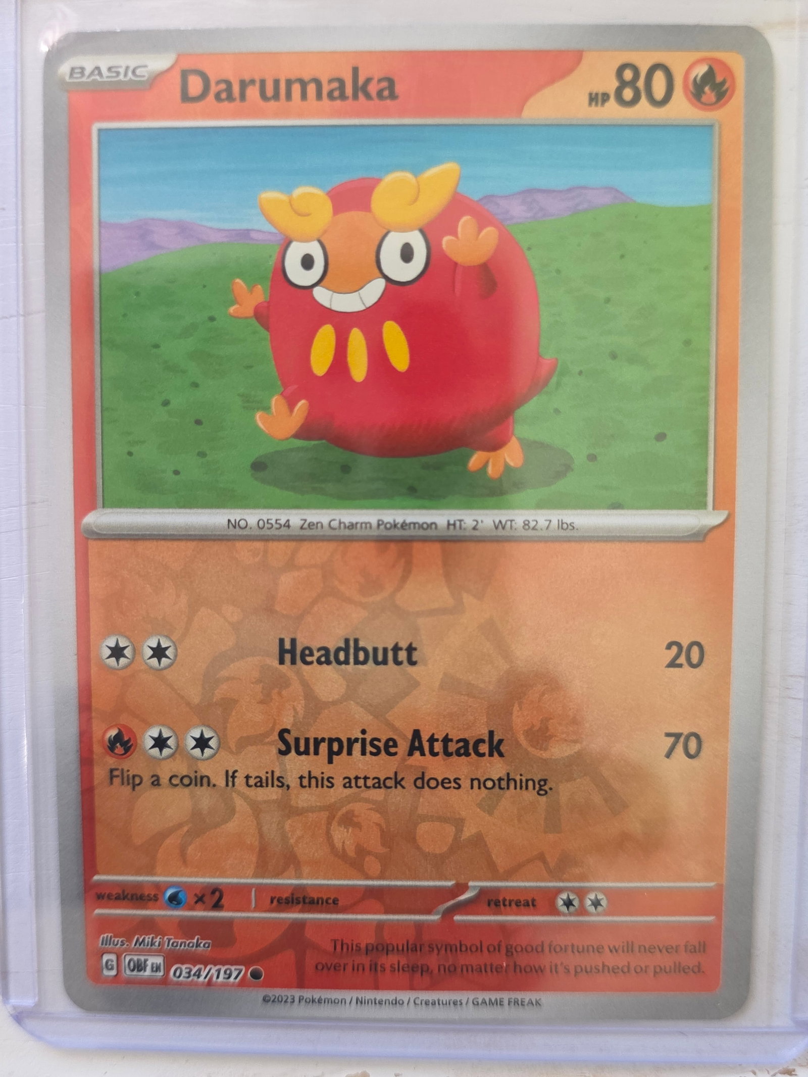 2023 Darumaka Obsidian Flames 034/197 Reverse Holo: 2023 Darumaka Basic card 034/197 from Scarlet and Violet Obsidian Flames. 80 HP Fire type. Headbutt 20 and Surprise Attack 70. Reverse holo card. Preowned and stored in penny sleeve and top loader. So