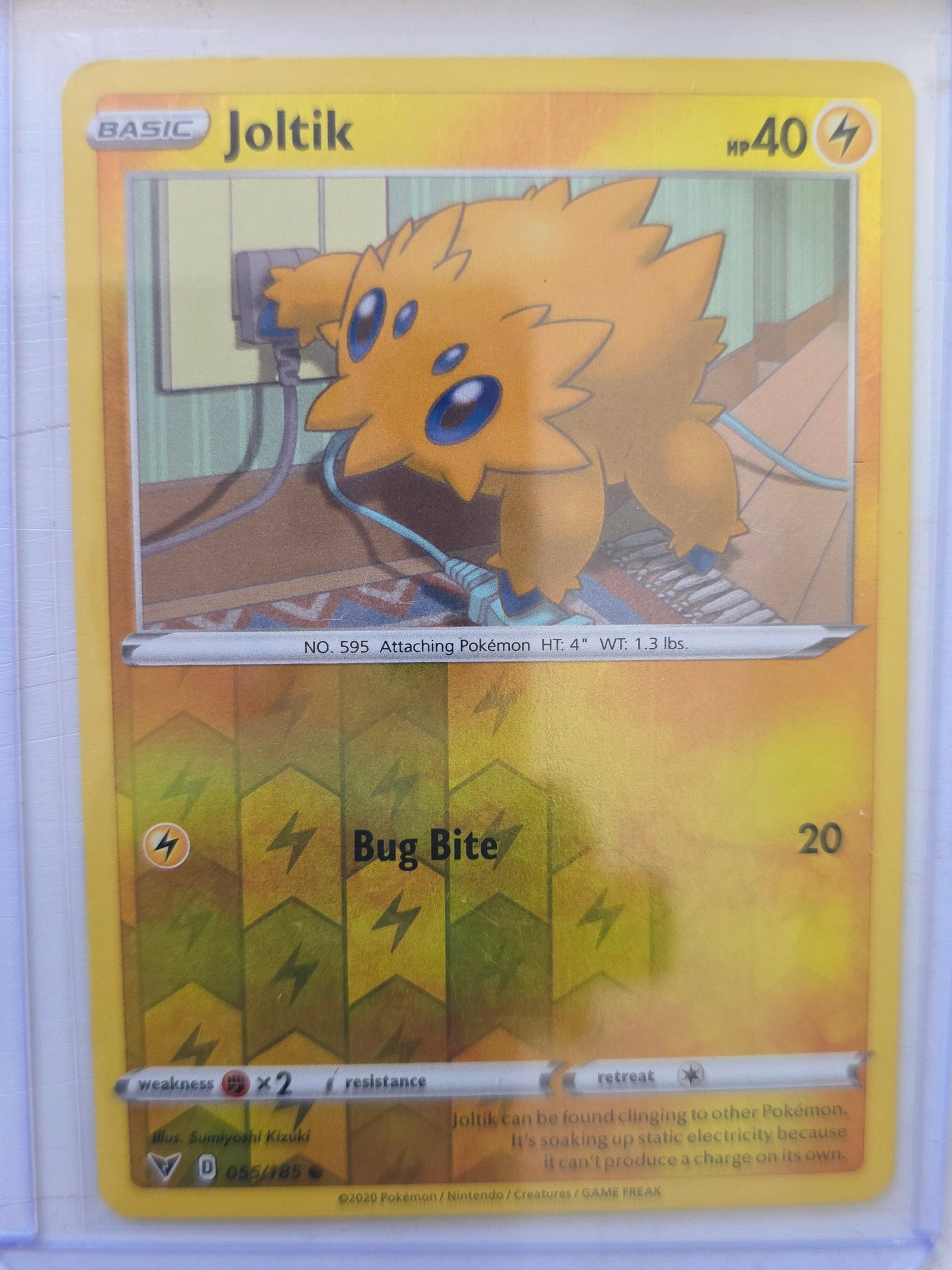 2020 Joltik Vivid Voltage 056/185 Reverse Holo Pokemon Card: 2020 Pokemon Joltik reverse holo card numbered 056/185 from the Sword & Shield Vivid Voltage expansion set. Illustrated by Sumiyoshi Kizuki. Reverse holographic foil pattern across the card surface. C
