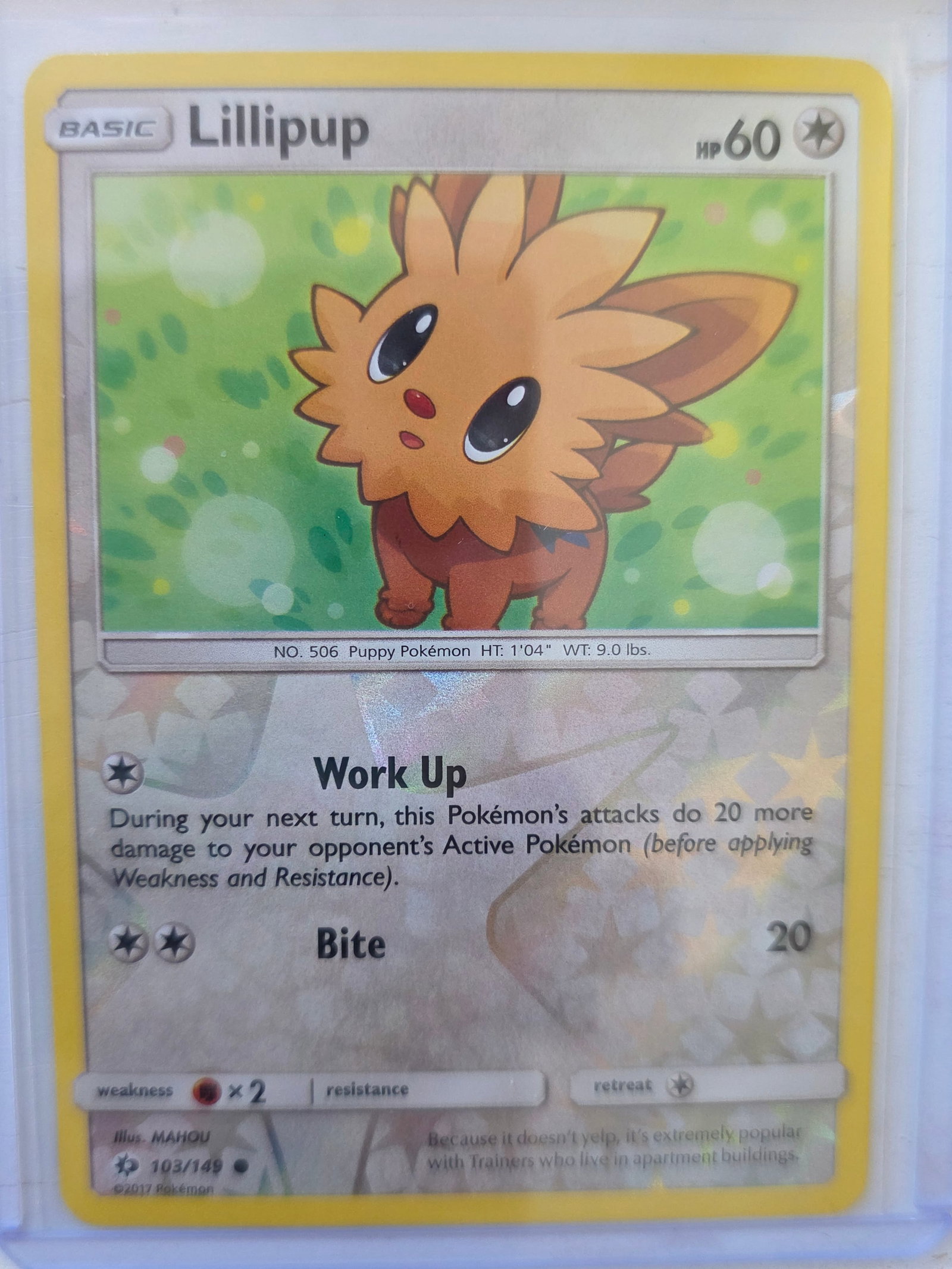 2017 Lillipup Sun & Moon Base Set 103/149 Reverse Holo Pokemon Card: 2017 Pokemon Lillipup reverse holo card numbered 103/149 from the Sun & Moon Base expansion set. Illustrated by MAHOU. Reverse holographic foil pattern across the card surface. Card stored in penny sl