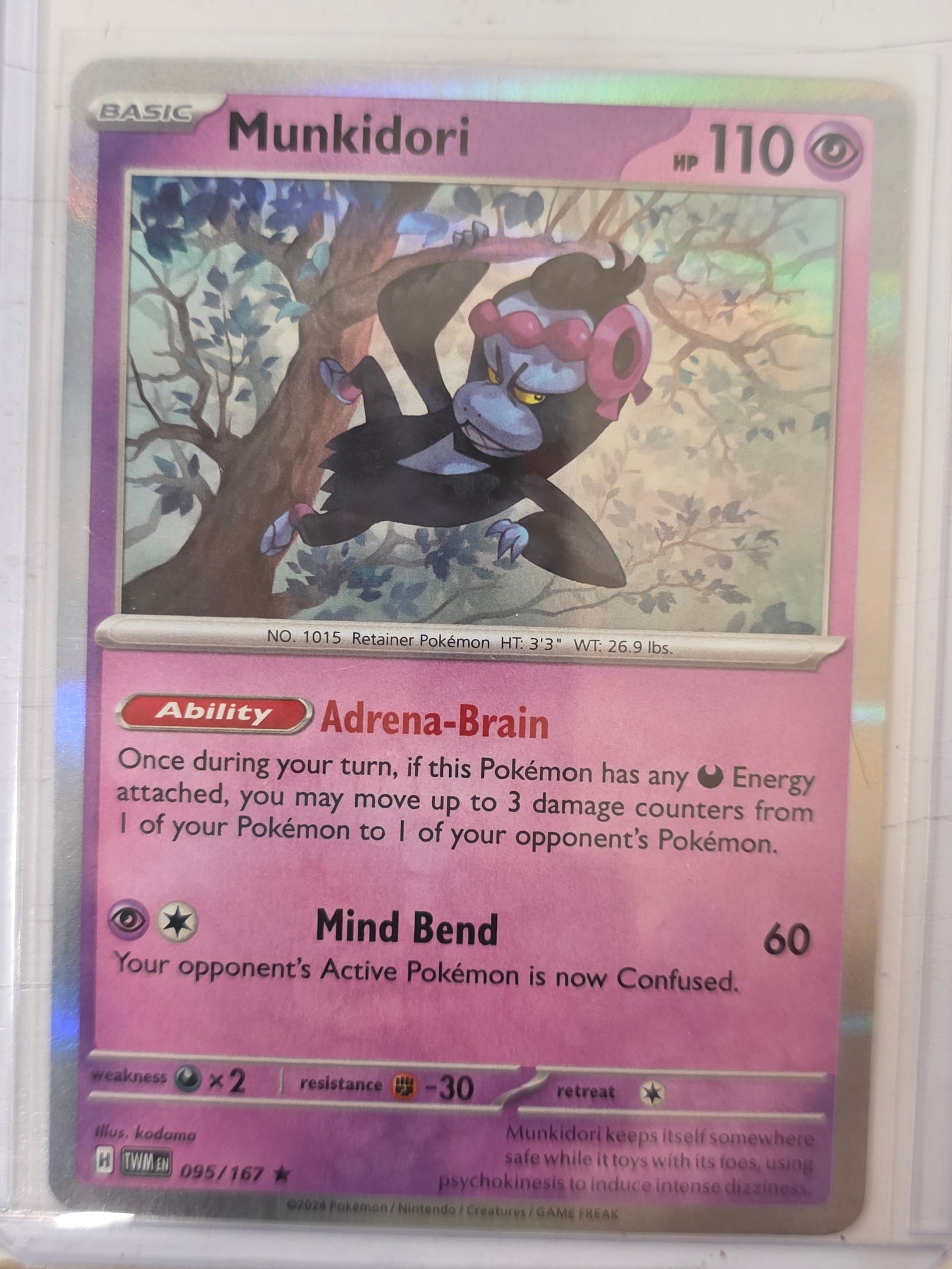 2024 Munkidori Twilight Masquerade 095/167 Holo Pokemon Card: 2024 Pokemon Munkidori holographic card numbered 095/167 from the Scarlet & Violet Twilight Masquerade expansion set. Illustrated by kodama. Standard holographic finish across the illustration area. C