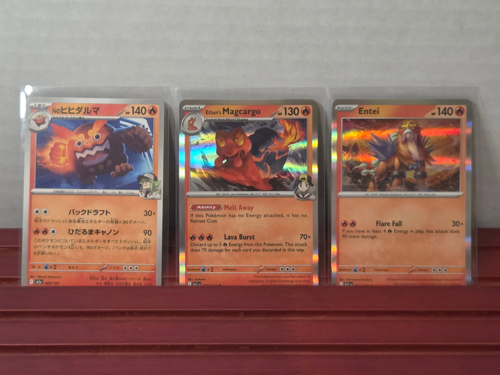 2023 Entei Scarlet & Violet 025/197 Holo with Magcargo & Darumaka Lot: Three card lot featuring Entei holo alongside Ethan’s Magcargo and Darumaka. Includes a mix of holo and standard cards from the Scarlet & Violet era. Cards are preowned and stored in penny sleeves a