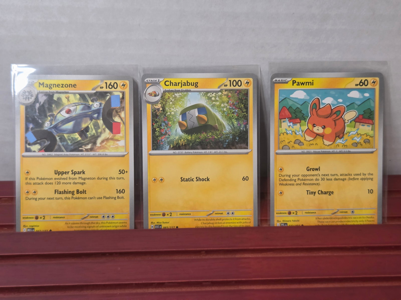2023 Magnezone Charjabug Pawmi Mixed Pokemon Card Lot: Mixed electric type lot featuring Magnezone, Charjabug, and Pawmi from modern Pokemon sets. Nice variety with evolution and basic cards, strong artwork and color for display or collection building. Ca