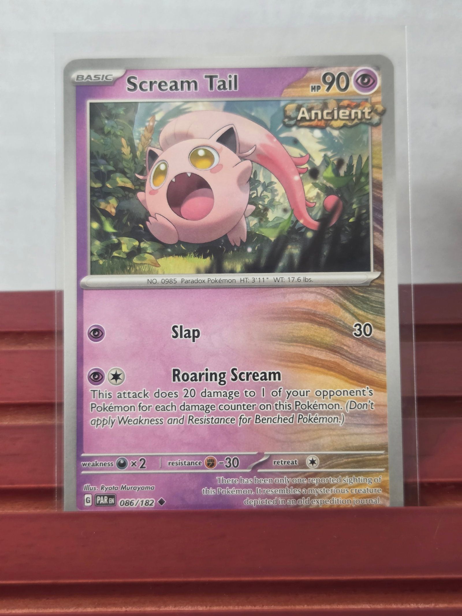 2023 Scream Tail Paradox Rift 086/182 Holo: Preowned 2023 Pokemon Scream Tail from the Paradox Rift set. Holo rare card featuring the Ancient designation. Stored in a penny sleeve and top loader. Clean overall appearance with light visible hand