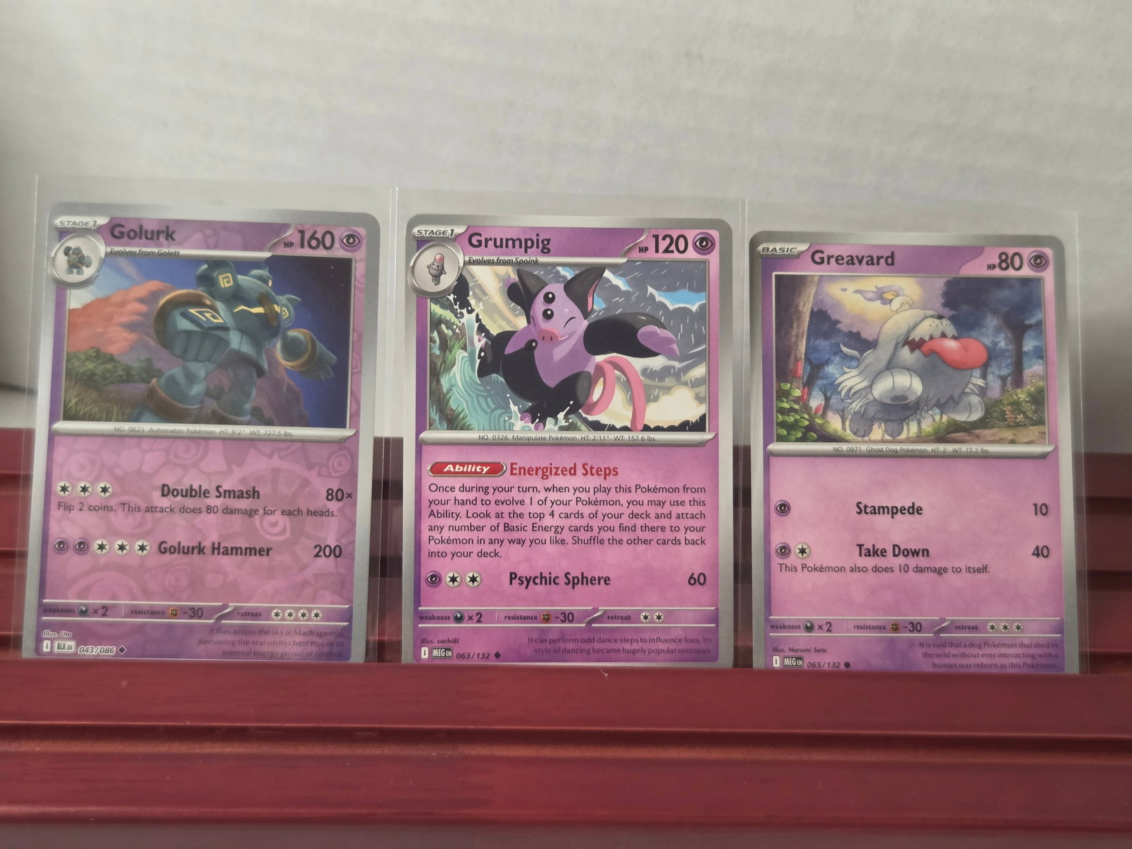 Golurk Grumpig Greavard Paradox Rift 043 063 065 Holo: Lot of 3 Pokémon cards including Golurk, Grumpig, and Greavard from the Scarlet & Violet Paradox Rift set. Includes holo and standard cards as shown. Cards are preowned and have been stored in penny