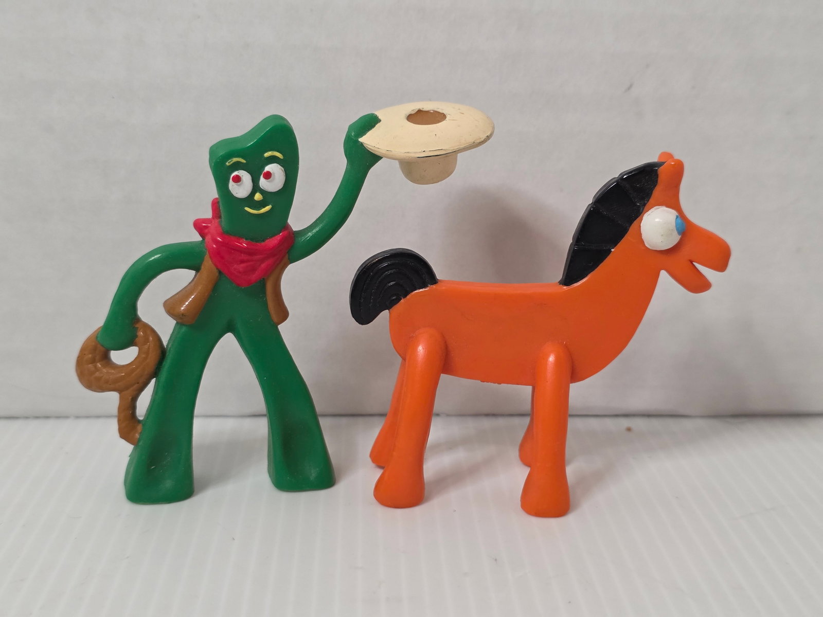 Vintage Gumby Pokey Western Cowboy Figures 1993 Prema Toy Set: This lot features a vintage Gumby and Pokey Western themed figure set from 1993, produced under Prema Toy Co. Inc. and based on the classic Art Clokey characters. Gumby is shown in a cowboy outfit hol