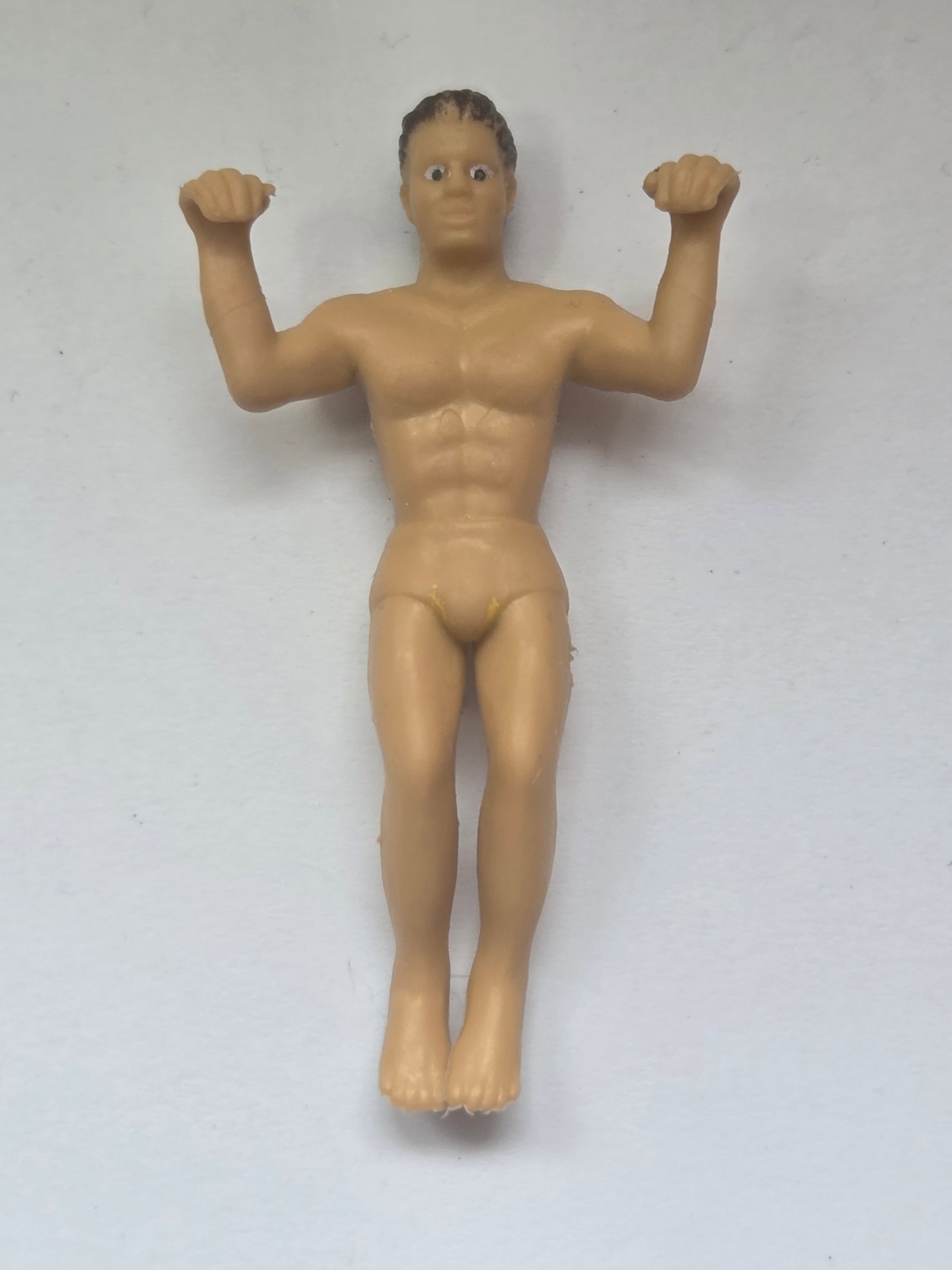 Vintage Miniature Wrestler PVC Figure M.U.S.C.L.E Style Wrestling Toy: This lot features a small vintage miniature wrestler figure made of molded plastic, depicting a muscular male wrestler in a flexing pose. The figure resembles the style of 1980s–1990s wrestling mini