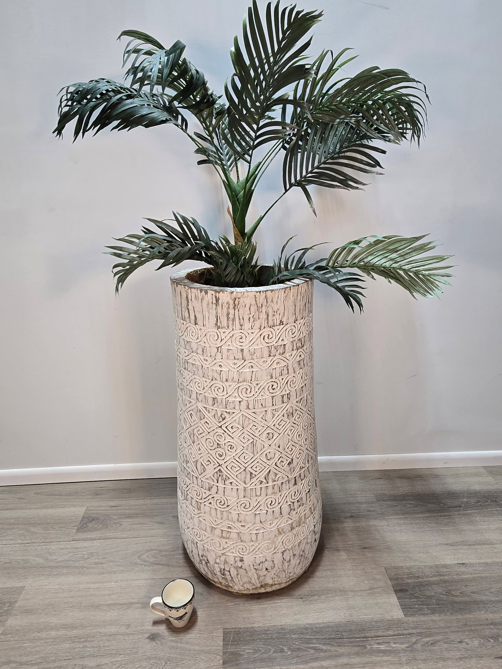 Hand-Carved Coconut Tree Planter: Hand-Carved Coconut Tree PlanterThis unique floor vase was handcrafted in Bali, Indonesia from an actual coconut tree.The outside of the tree was carved with patterns associated with the indigenous