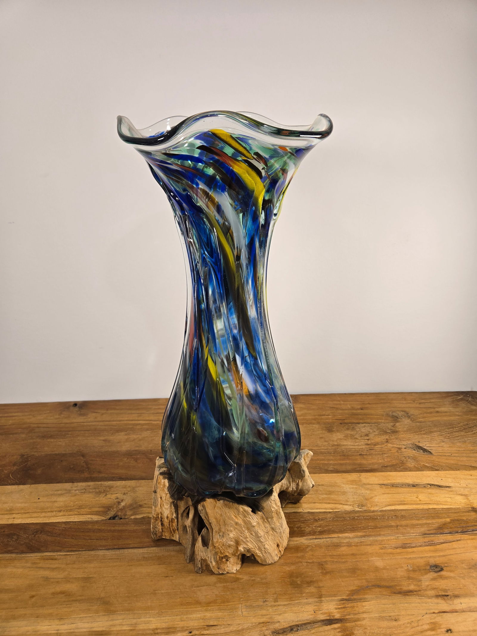 Blown Glass Vase with Teak Wood: Blown Glass Vase with Teak Wood BaseThis unique vase was hand-blown in Bali, Indonesia. The vase is specific to the teak wood that it was formed on, and no two are alike.This piece is brand