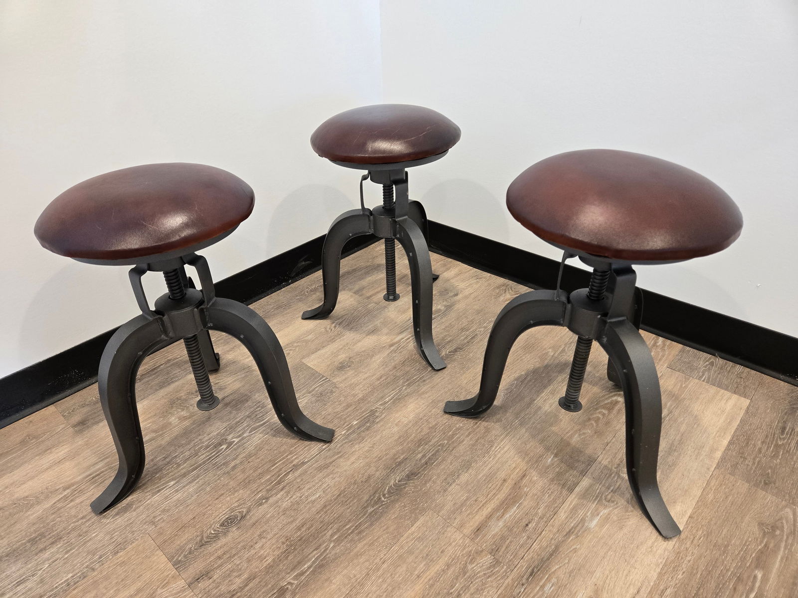 Adjustable Height Stool - Set of 3: Adjustable Height Stool - Set of 3These unique, industrial stools feature a faux leather seat and adjustable seat height.These stools are brand new. One of them has a slight indention on one of the le