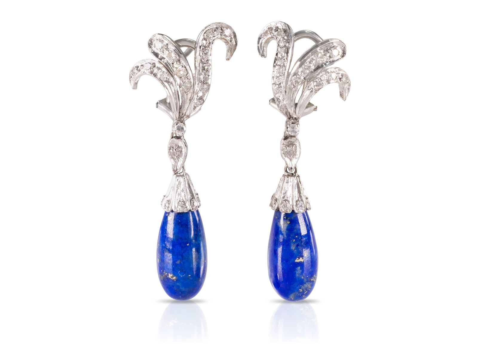 Lapis lazuli and diamond clip-on earrings in white gold: Lapis lazuli and diamond clip-on earrings in white goldAttractive clip-on earrings in white gold, not hallmarked, fineness tested at approximately 333. Set in the clip-on earrings are two lapis lazuli