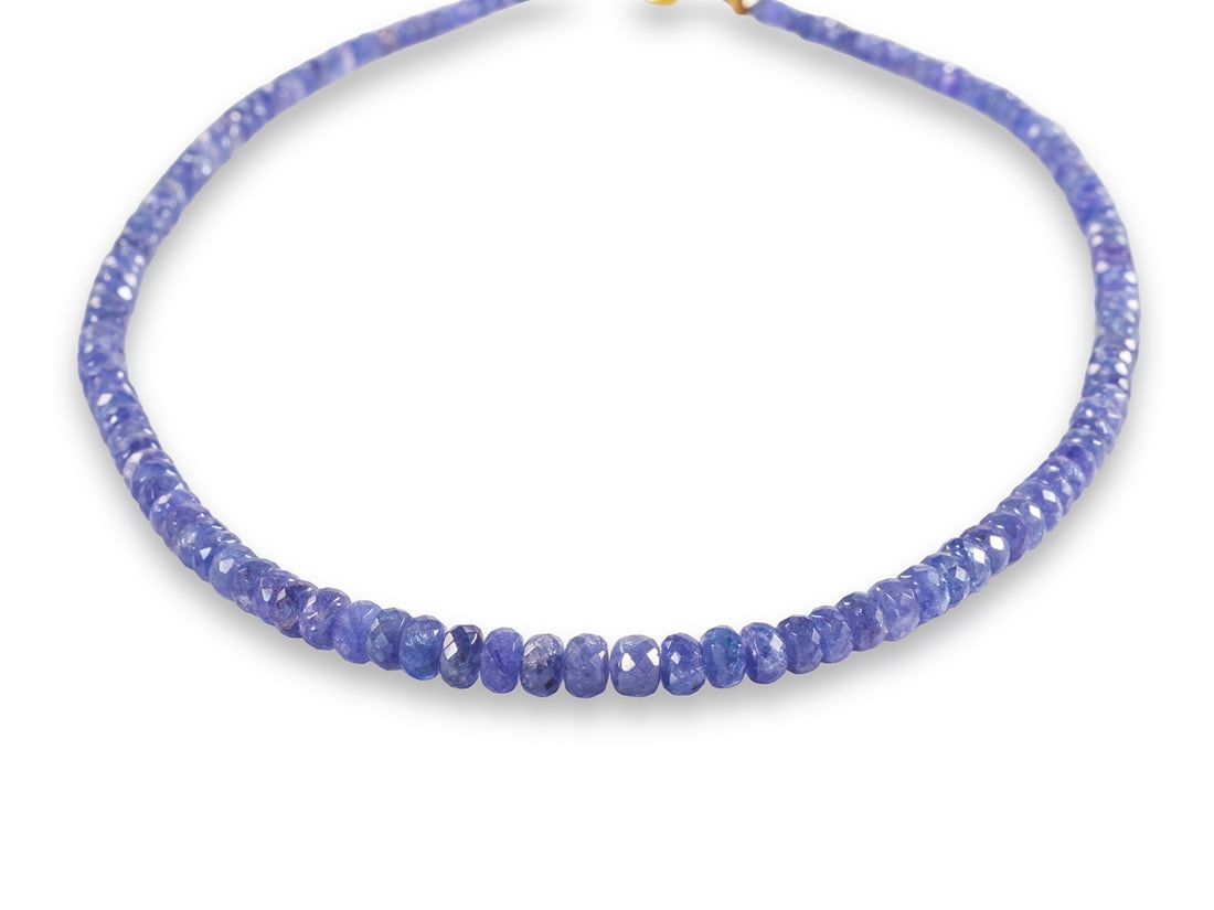 Faceted Tanzanite Necklace with 14k Yellow Gold Clasp: Faceted Tanzanite Necklace with 14k Yellow Gold Clasp46 cm long necklace made of faceted tanzanites, approximately 4 to 6 mm in diameter, with an 8.3 mm ball clasp in 14k yellow gold. Very good condit